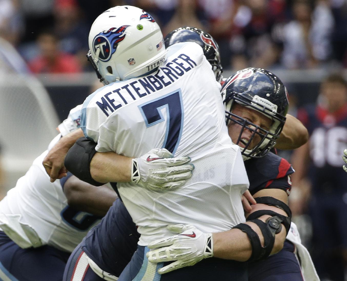 Houston Texans defensive end J.J. Watt tackles Tennessee Titans quarterback Zach Mettenberger (7) during the first half of an NFL football game Sunday, Nov. 30, 2014, in Houston. (AP Photo/David J. Phillip)