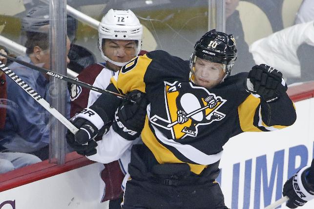 Pittsburgh Penguins' Christian Ehrhoff (10) checks Colorado Avalanche's Jarome Iginla (12) into the boards during the first period of an NHL hockey game in Pittsburgh on Thursday, Dec. 18, 2014. (AP Photo/Gene J. Puskar)