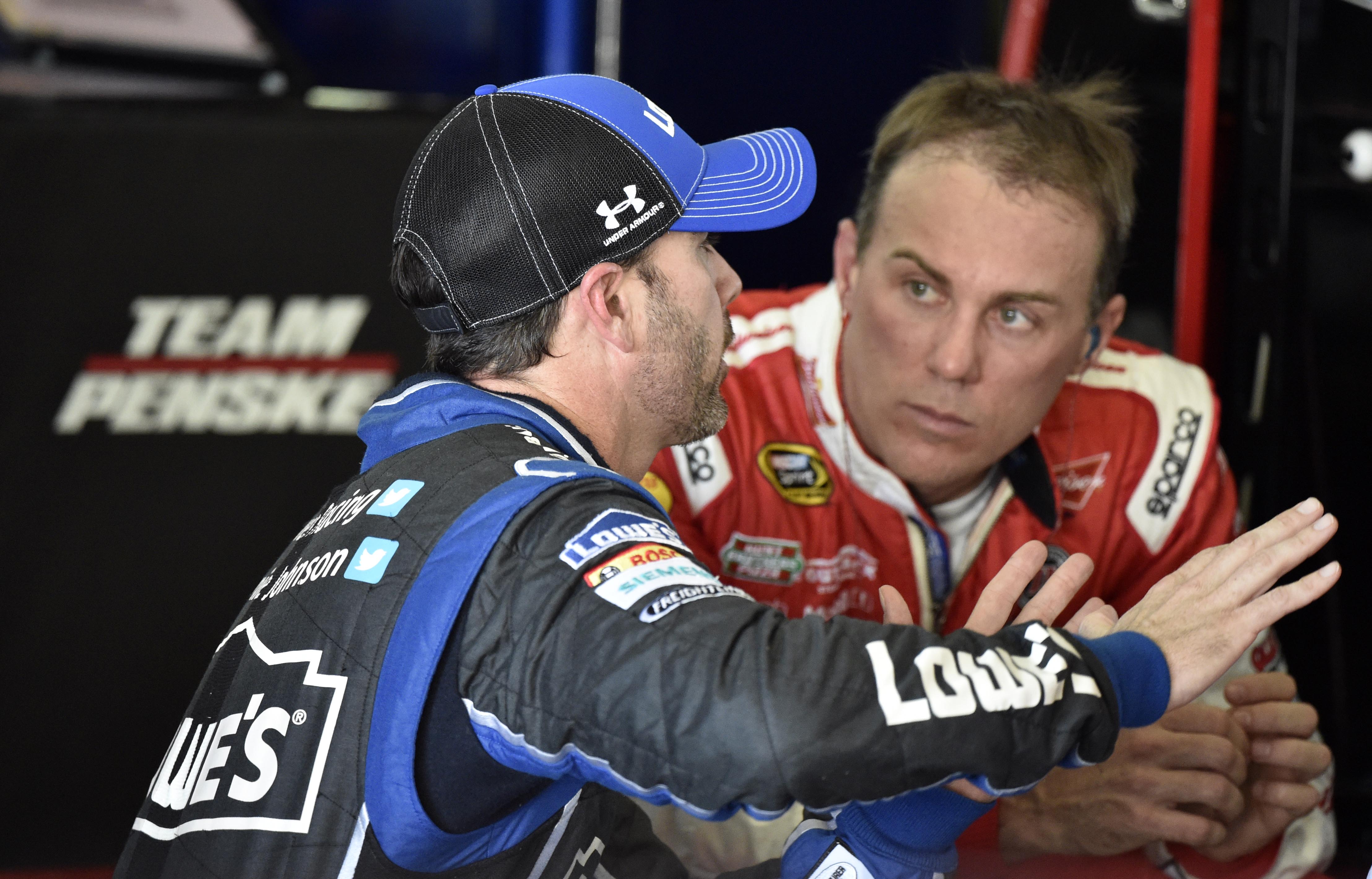 NASCAR Sprint Cup Series driver Kevin Harvick (right) talks with Jimmie Johnson during practice for the Ford EcoBoost 400 at Homestead-Miami Speedway. (USA TODAY Sports)
