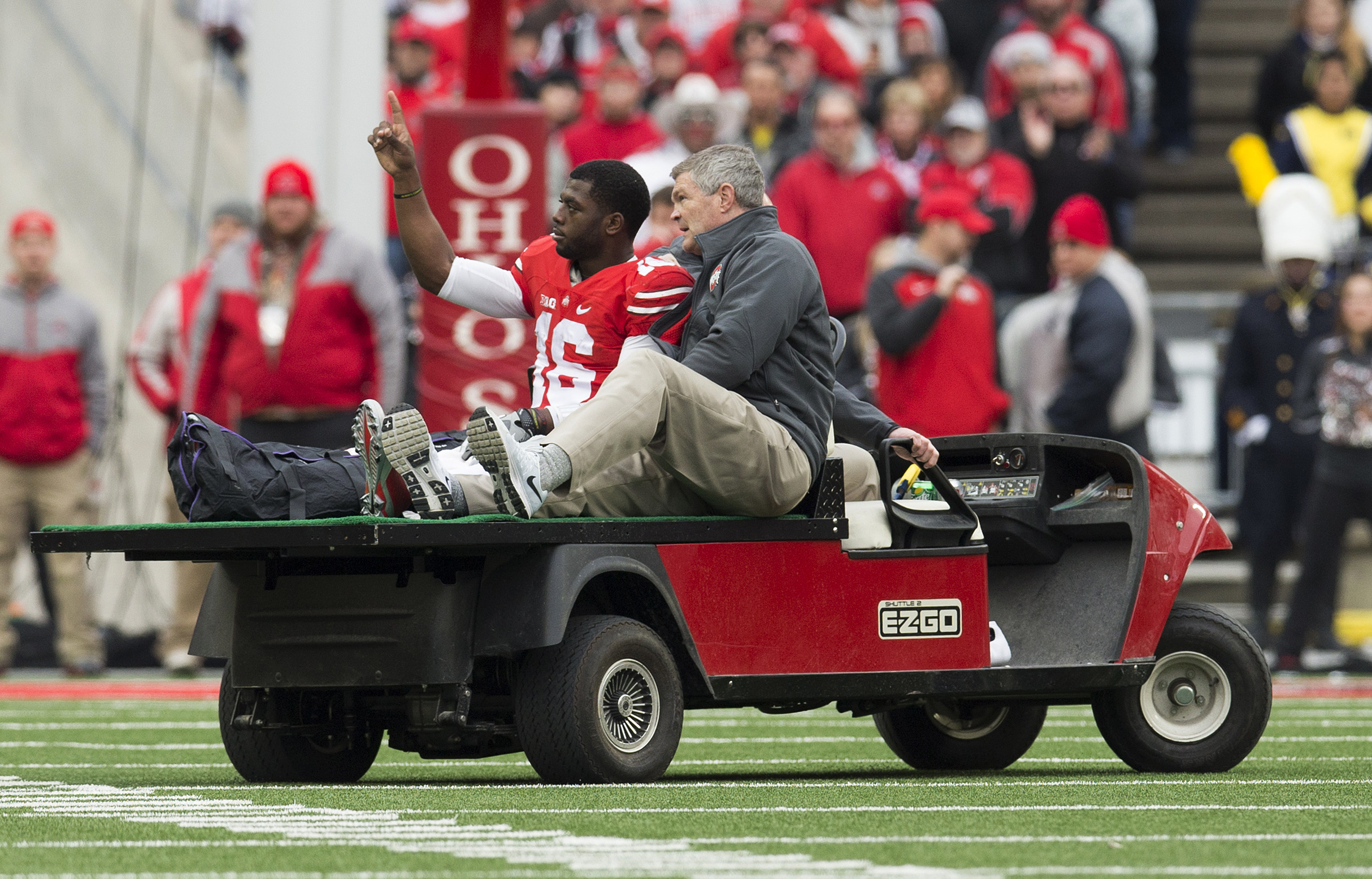 Nov 29, 2014; Columbus, OH, USA; Ohio State Buckeyes quarterback J.T. Barrett (16) is taken from the field after an injury against the Michigan Wolverines at Ohio Stadium. (Greg Bartram-USA TODAY Sports)