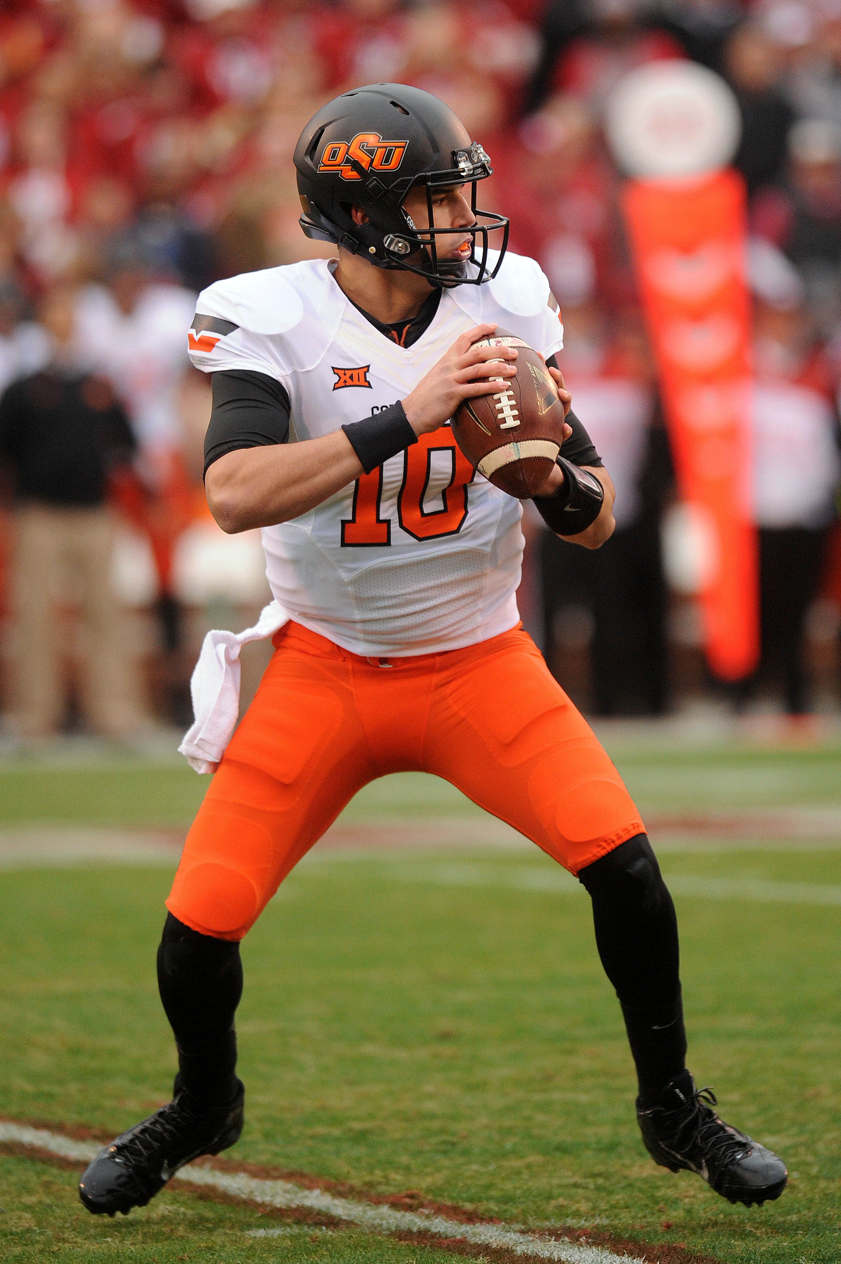Dec 6, 2014; Norman, OK, USA; Oklahoma State Cowboys quarterback Mason Rudolph (10) looks to pass the ball against the Oklahoma Sooners during the first quarter at Gaylord Family - Oklahoma Memorial Stadium. (Mark D. Smith-USA TODAY Sports)