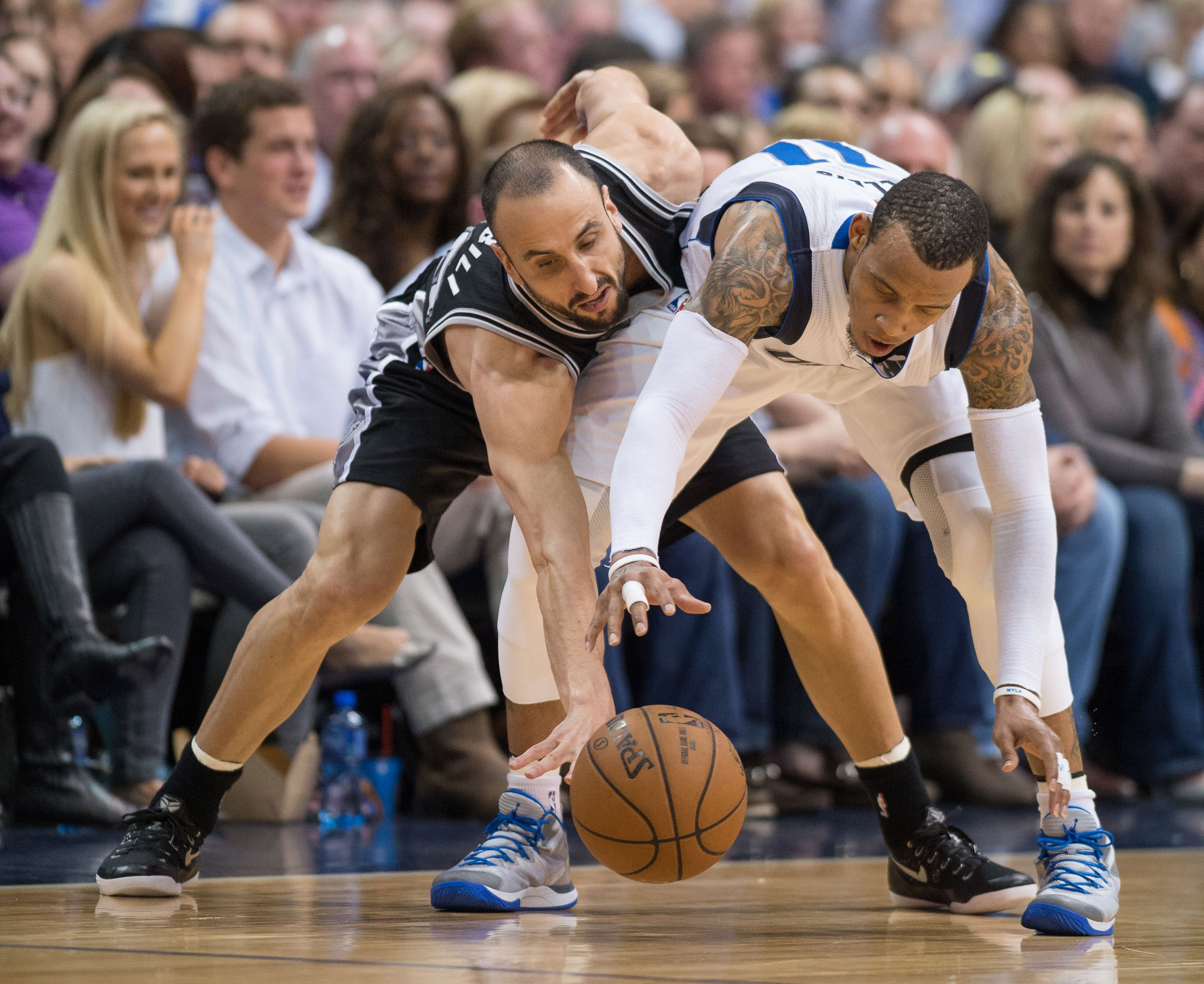 Mar 24, 2015; Dallas, TX, USA; San Antonio Spurs guard Manu Ginobili (20) tires to steal the ball away from Dallas Mavericks guard Monta Ellis (11) during the second half at the American Airlines Center. The Mavericks won 101-94. (Jerome Miron-USA TODAY Sports)