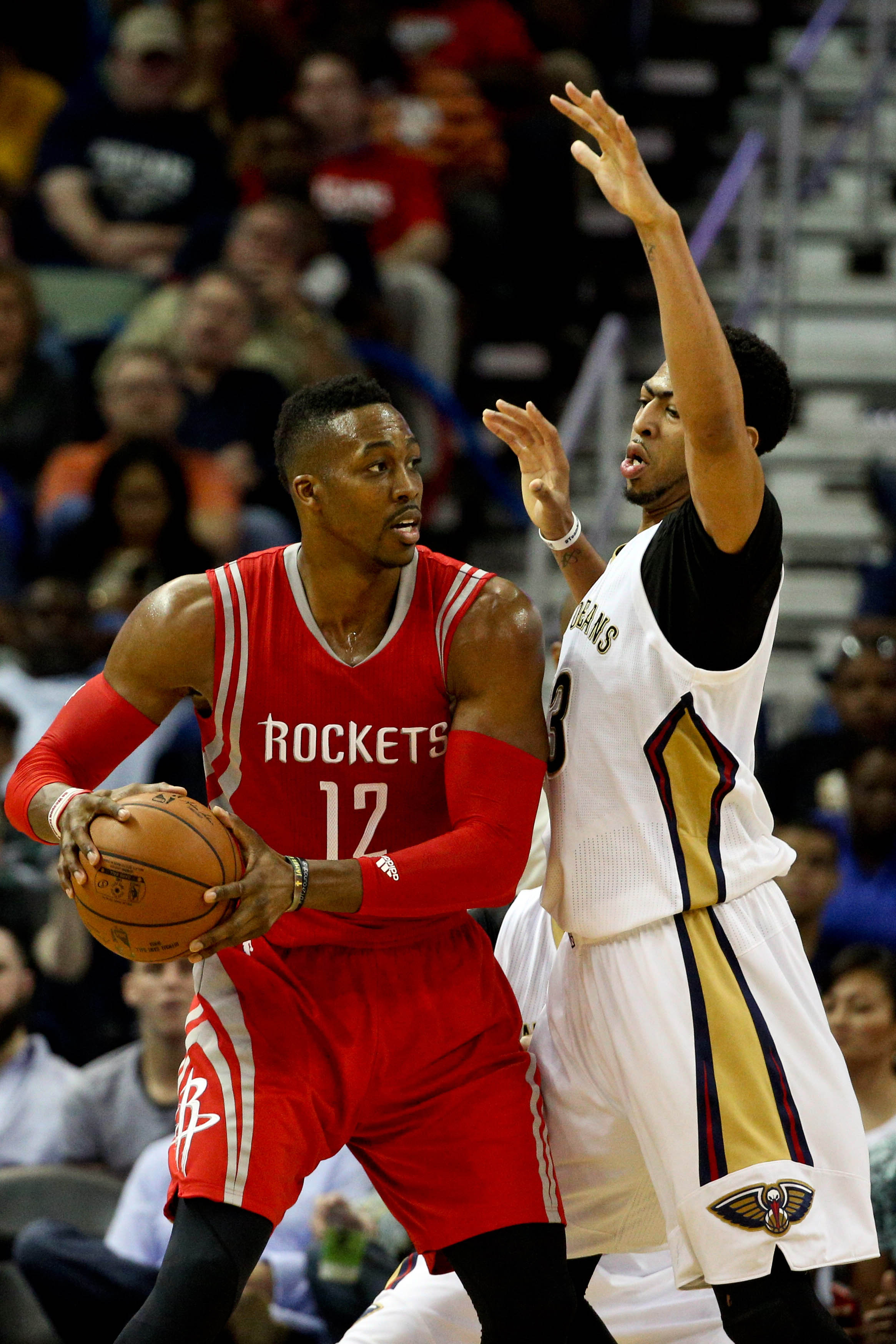 Mar 25, 2015; New Orleans, LA, USA; Houston Rockets center Dwight Howard (12) is defended by New Orleans Pelicans forward Anthony Davis (23) during the second half of a game at the Smoothie King Center. The Rockets defeated the Pelicans 95-93. (Derick E. Hingle-USA TODAY Sports)