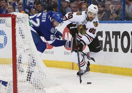 Jun 13, 2015; Tampa, FL, USA; Chicago Blackhawks center Antoine Vermette (80) battles for the puck with Tampa Bay Lightning defenseman Andrej Sustr (62) in the third period game five of the 2015 Stanley Cup Final at Amalie Arena. Mandatory Credit: Kim Klement-USA TODAY Sports