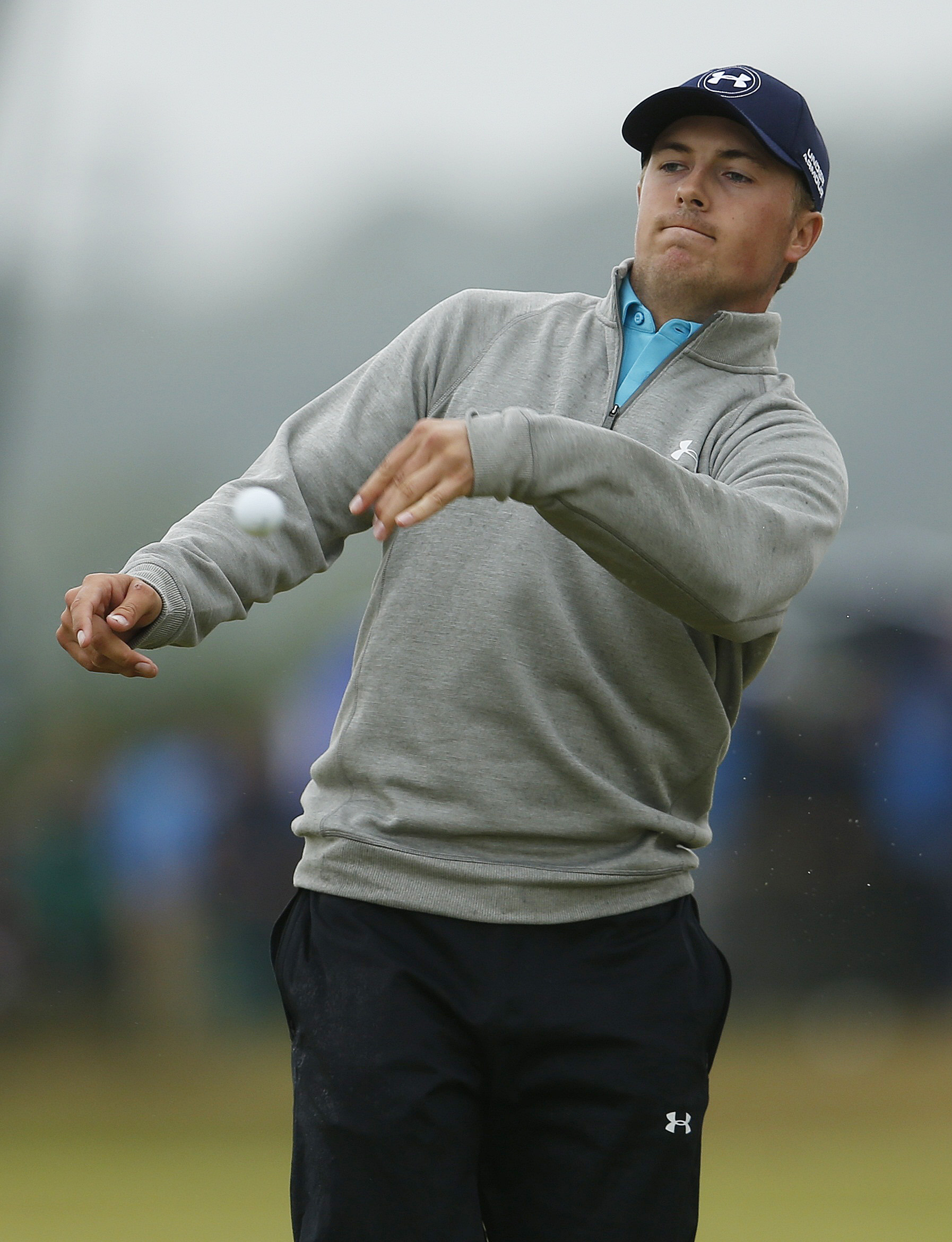 Jordan Spieth throws his ball into the crowd after his double bogey on the eighth hole. (REUTERS)