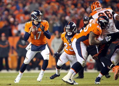 Dec 28, 2015; Denver, CO, USA; Denver Broncos quarterback Brock Osweiler (17) looks to pass the ball during the overtime period against the Cincinnati Bengals at Sports Authority Field at Mile High.  The Broncos won 20-17 in overtime. Mandatory Credit: Chris Humphreys-USA TODAY Sports