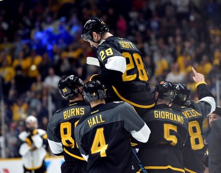 Jan 31, 2016; Nashville, TN, USA; Pacific Division forward John Scott (28) of the Montreal Canadiens is picked up by his teammates after beating the Atlantic Division during the championship game of the 2016 NHL All Star Game at Bridgestone Arena. Mandatory Credit: Christopher Hanewinckel-USA TODAY Sports
