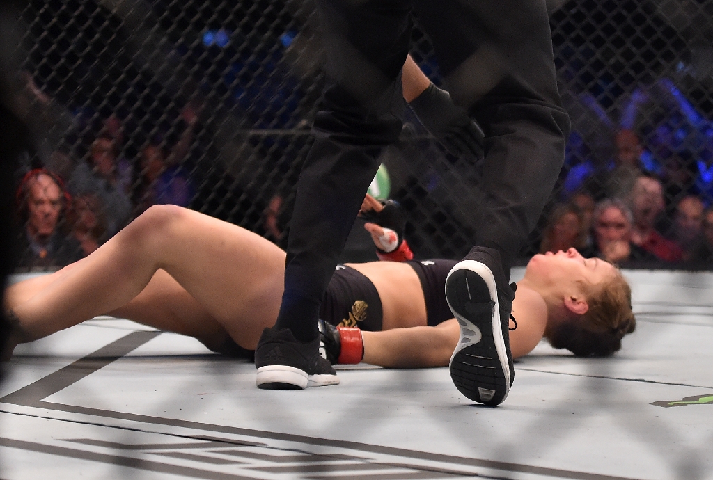 Ronda Rousey hits the canvas after being knocked out by Holly Holm. (AFP)