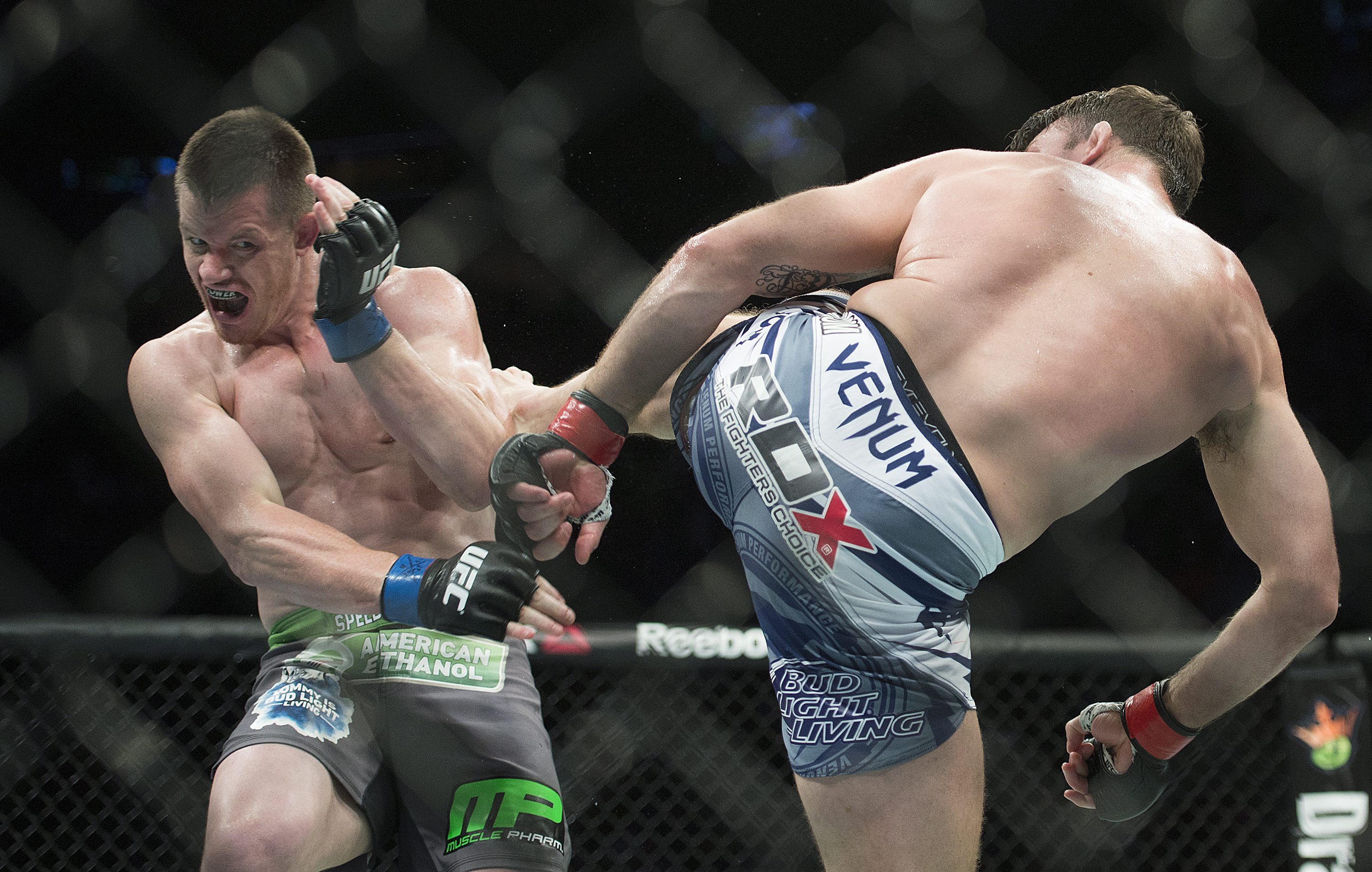 Michael Bisping (R) lands a kick to the body of CB Dollaway. (AP)