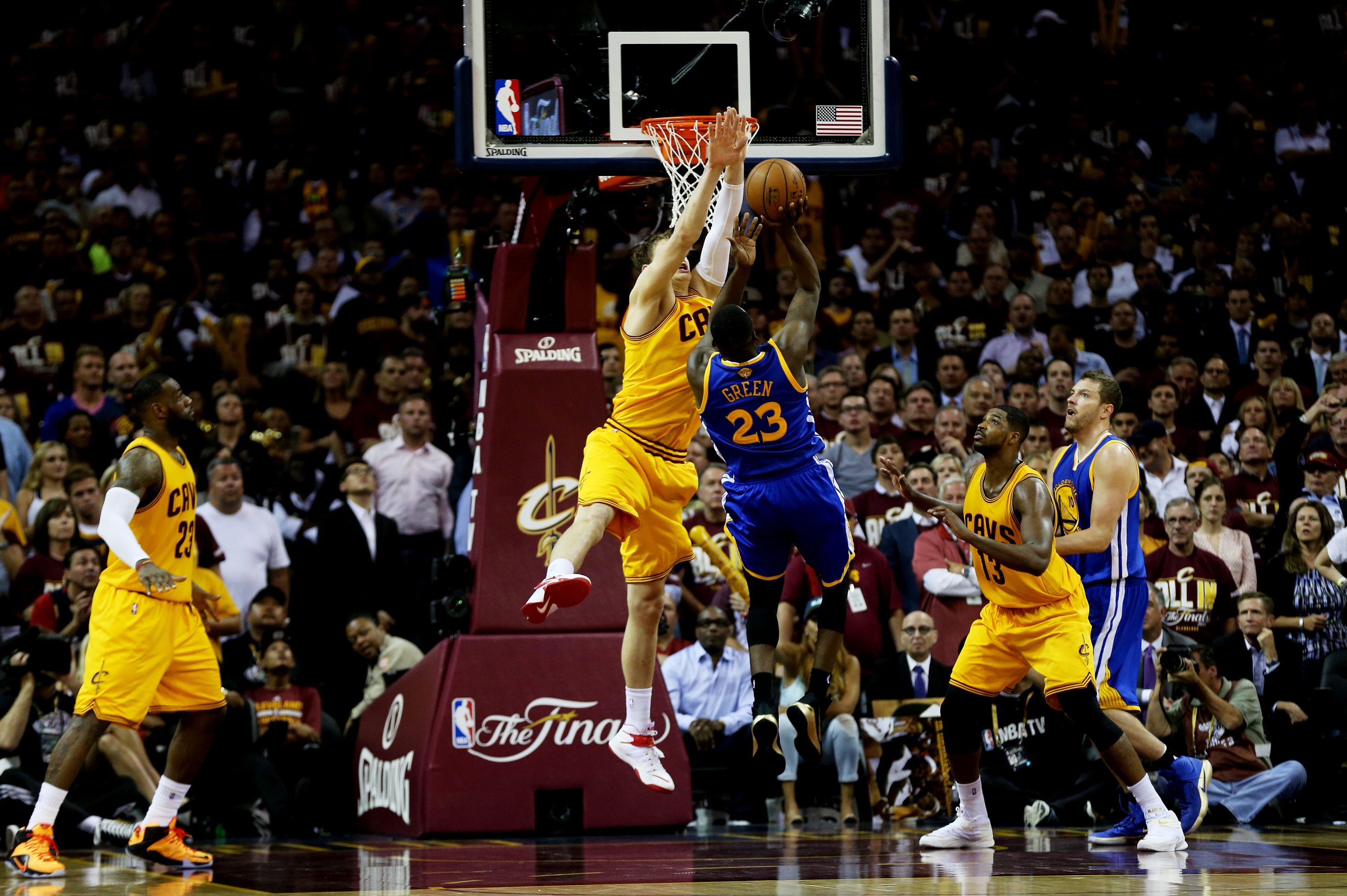 Draymond Green and Timofey Mozgov got well-acquainted at the rim. (Mike Ehrmann/Getty Images)