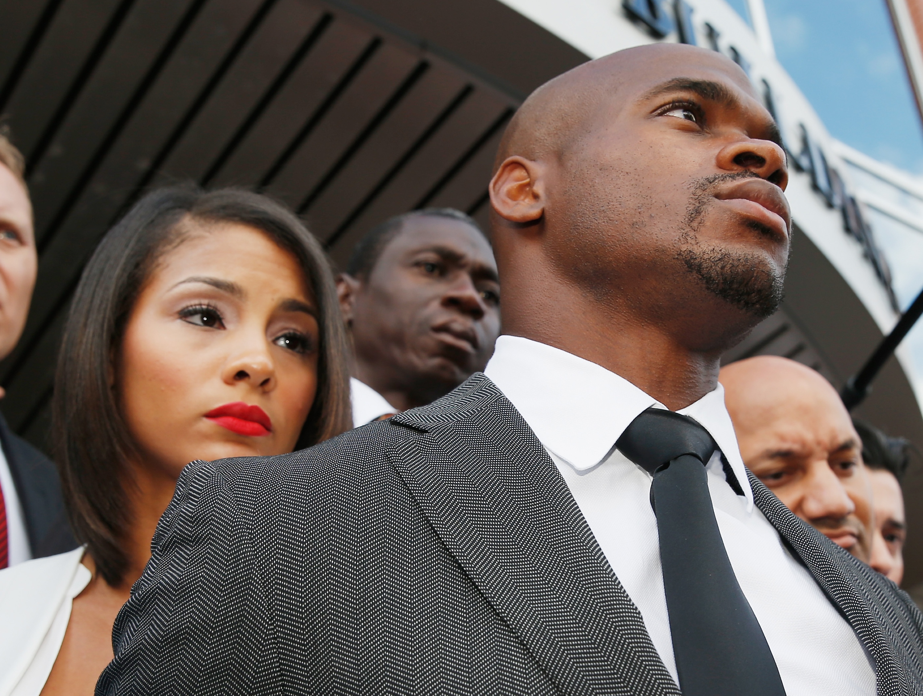 CONROE, TX - OCTOBER 08: NFL player Adrian Peterson of the Minnesota Vikings waits with his wife Ashley Brown after making a court appearance at the Montgomery County municipal building on October 8, 2014 in Conroe, Texas. Peterson did not enter a plea, and after about an hour in the courtroom the hearing was reset. A tentative trial date was set for Dec. 1. Petersen is facing charges of reckless or negligent injury to a child. (Photo by Scott Halleran/Getty Images)