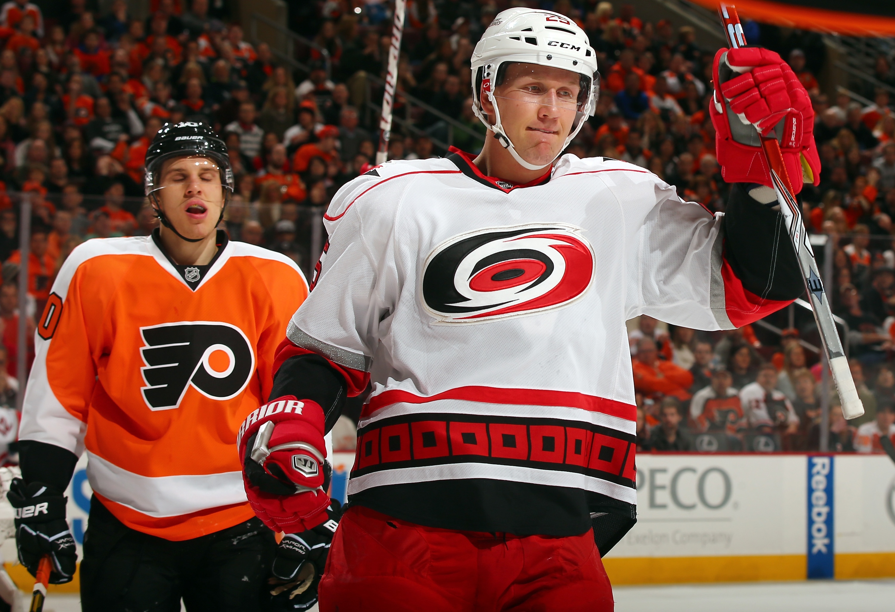 PHILADELPHIA, PA - FEBRUARY 02:  Joni Pitkanen #25 of the Carolina Hurricanes celebrates his goal in the first period as Brayden Schenn #10 of the Philadelphia Flyers reacts on February 2, 2013 at the Wells Fargo Center in Philadelphia, Pennsylvania.  (Photo by Elsa/Getty Images)