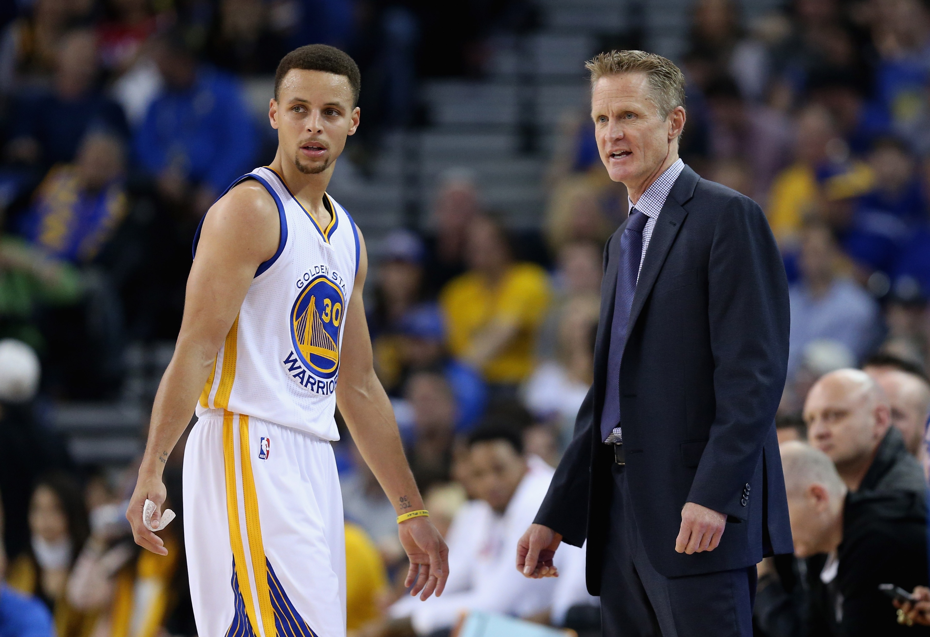 Steve Kerr checks to see if Stephen Curry needs a breather. (Ezra Shaw/Getty Images)