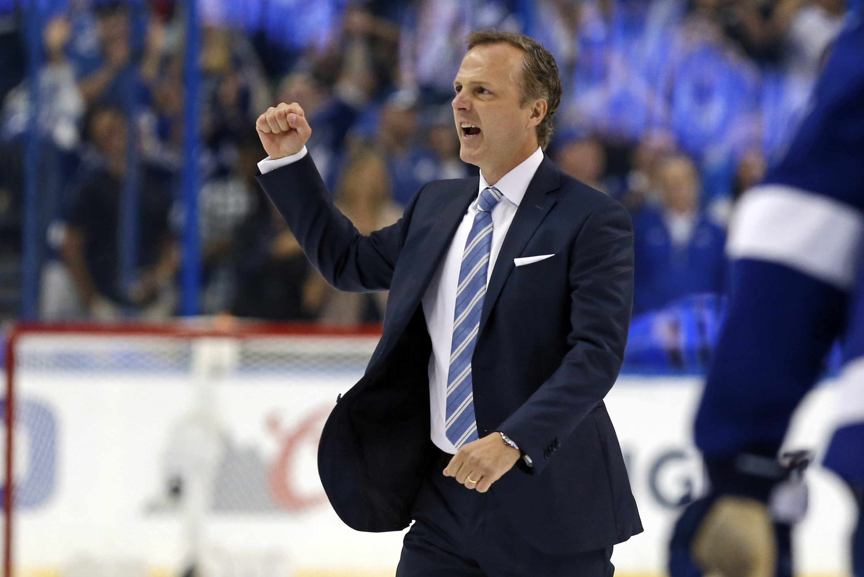 TAMPA, FL - APRIL 21:  Jon Cooper of the Tampa Bay Lightning celebrates after a series win over the Detroit Red Wings in Game Five of the Eastern Conference First Round during the 2016 NHL Stanley Cup Playoffs at Amalie Arena on April 21, 2016 in Tampa, Florida. (Photo by Mike Carlson/Getty Images)