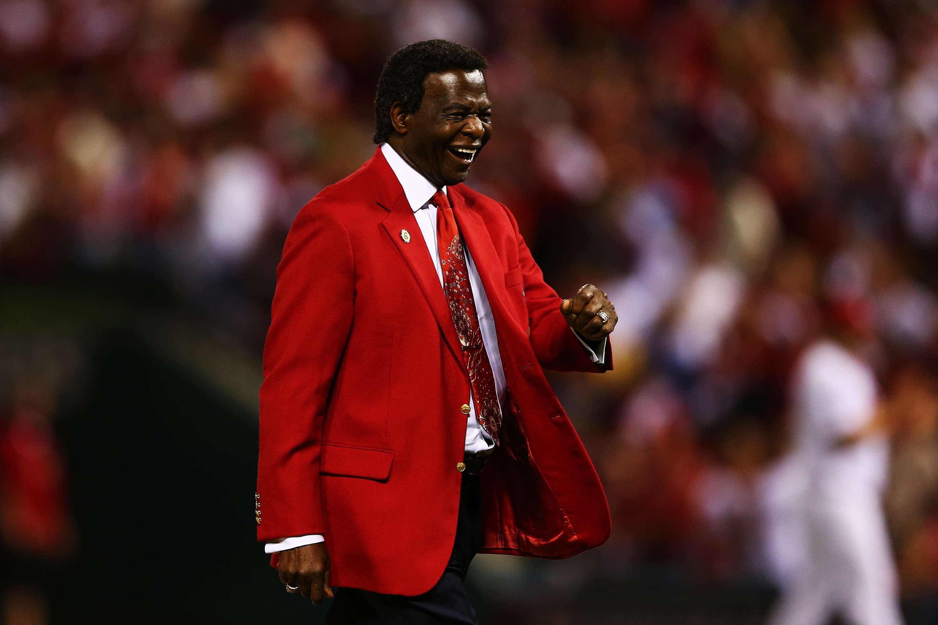 Lou Brock reacts after throwing out the ceremonial first pitch prior to Game Five of the National League Division Series in 2012. (Getty Images)