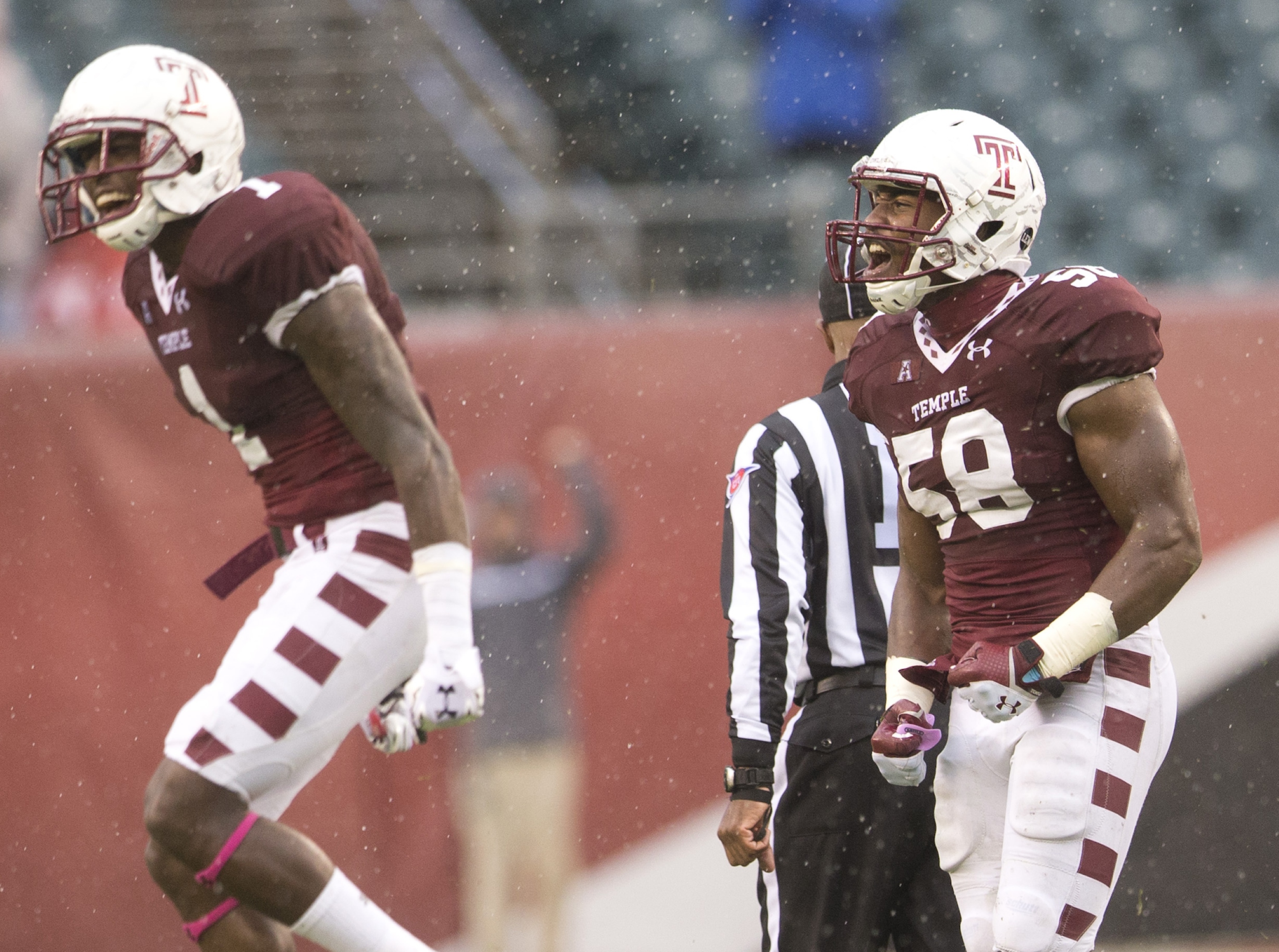 Haason Reddick #58 and Tavon Young #1 of the Temple Owls react after the Owls recovered a fumble in the first half against the East Carolina Pirates on November 1, 2014 at Lincoln Financial Field in Philadelphia, Pennsylvania. (Photo by Mitchell Leff/Getty Images)