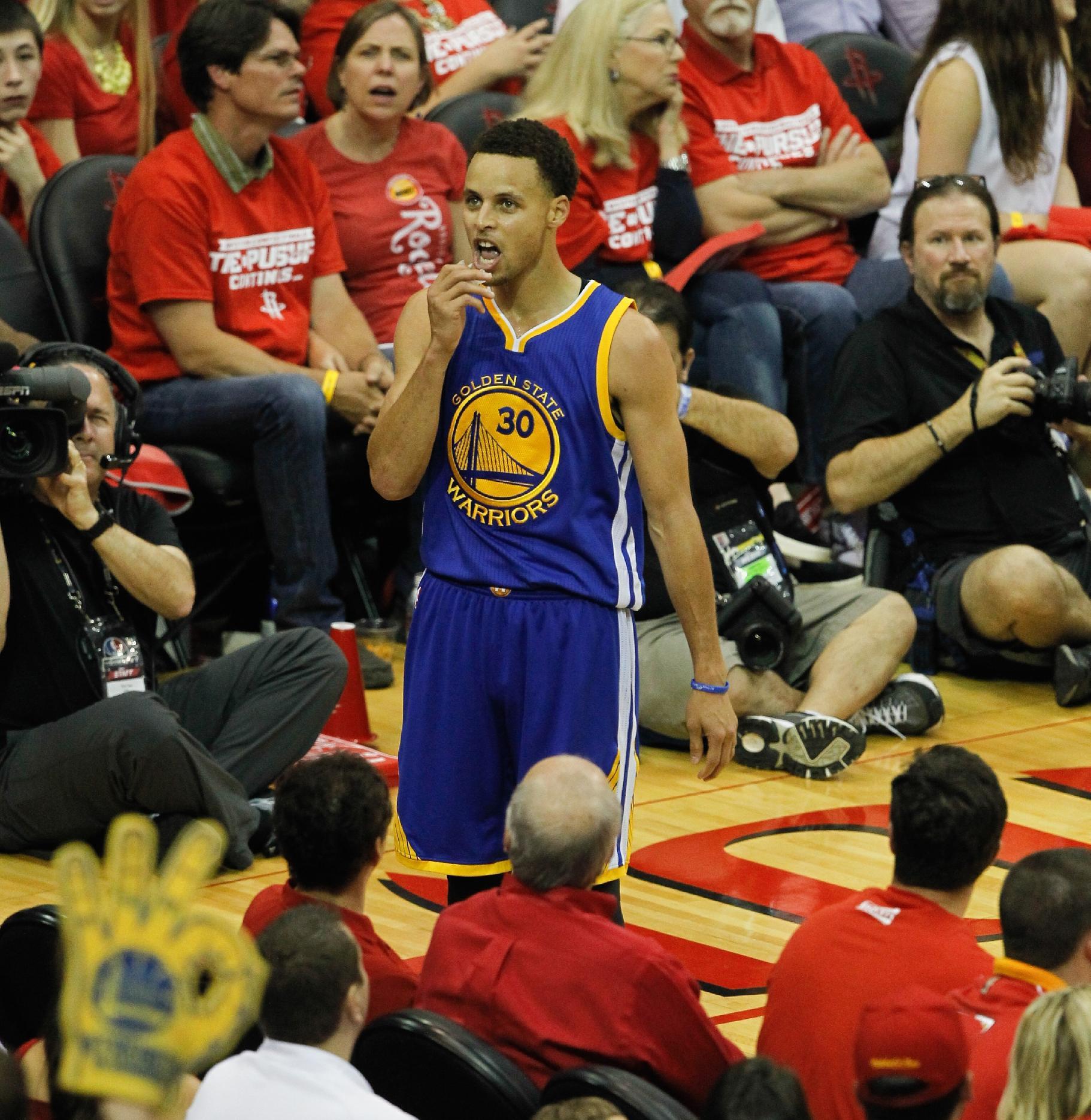 Stephen Curry stares down the crowd after drilling a corner 3. (Bob Levey/Getty Images)