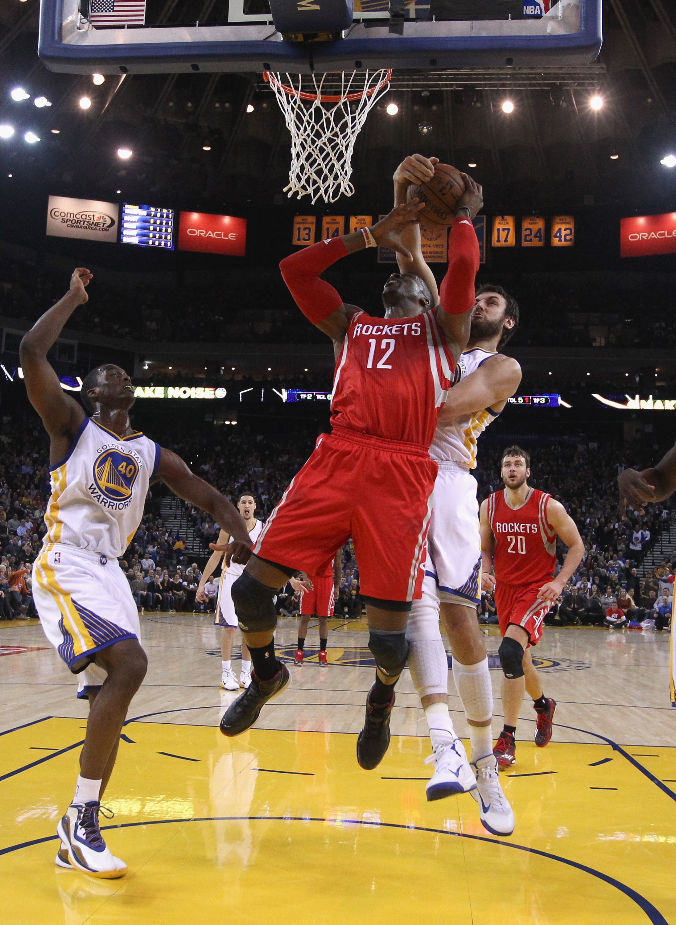 OAKLAND, CA - JANUARY 21: Dwight Howard #12 of the Houston Rockets has a shot blocked by Andrew Bogut #12 of the Golden State Warriors at ORACLE Arena on January 21, 2015 in Oakland, California. NOTE TO USER: User expressly acknowledges and agrees that, by downloading and or using this photograph, User is consenting to the terms and conditions of the Getty Images License Agreement. (Photo by Ezra Shaw/Getty Images)