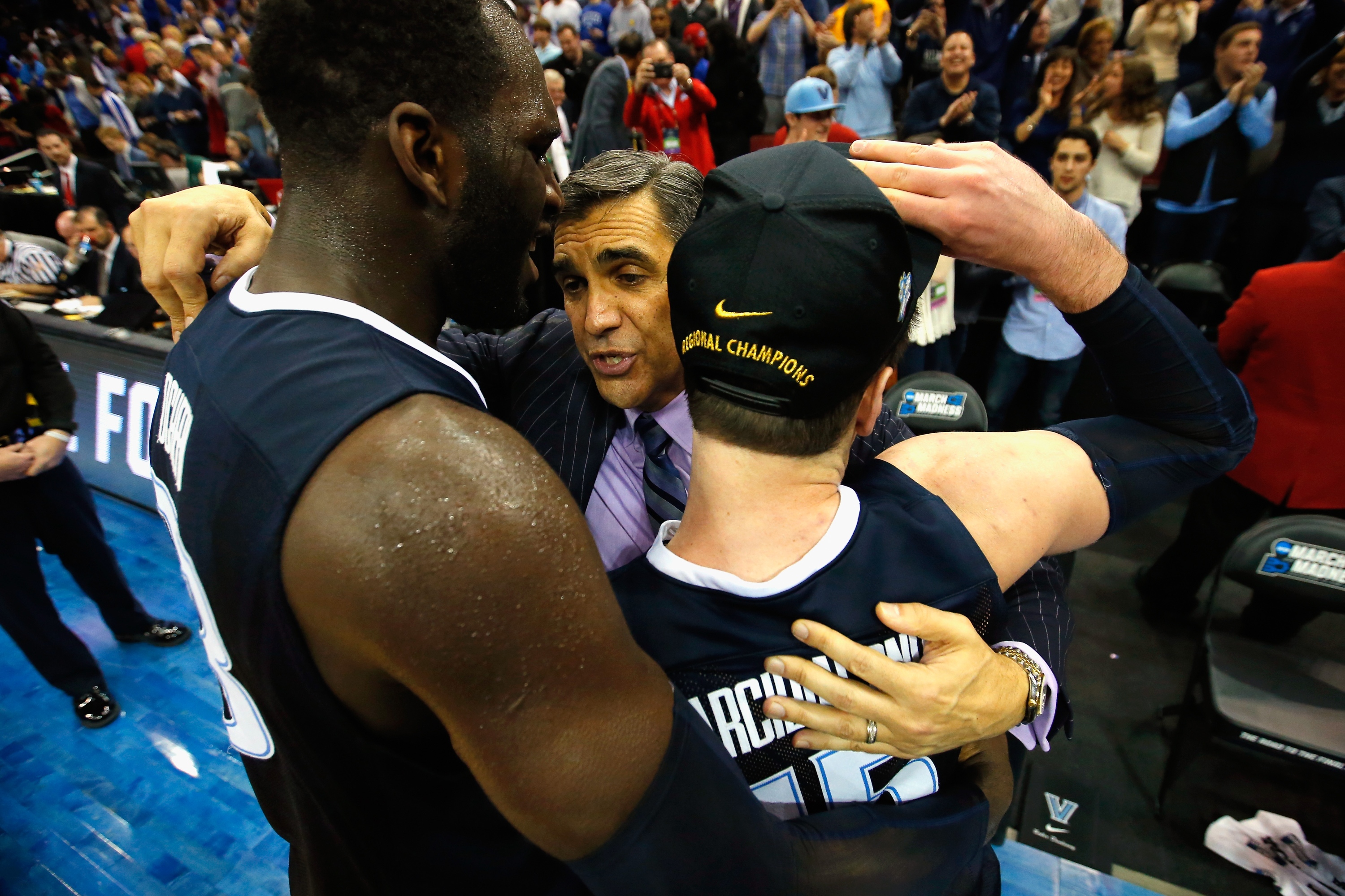 LOUISVILLE, KY - MARCH 26:  Head coach Jay Wright of the Villanova Wildcats (C) celebrates with Daniel Ochefu #23 and Ryan Arcidiacono #15 after defeating the Kansas Jayhawks 64-59 during the 2016 NCAA Men's Basketball Tournament South Regional at KFC YUM! Center on March 26, 2016 in Louisville, Kentucky.  (Photo by Kevin C. Cox/Getty Images)