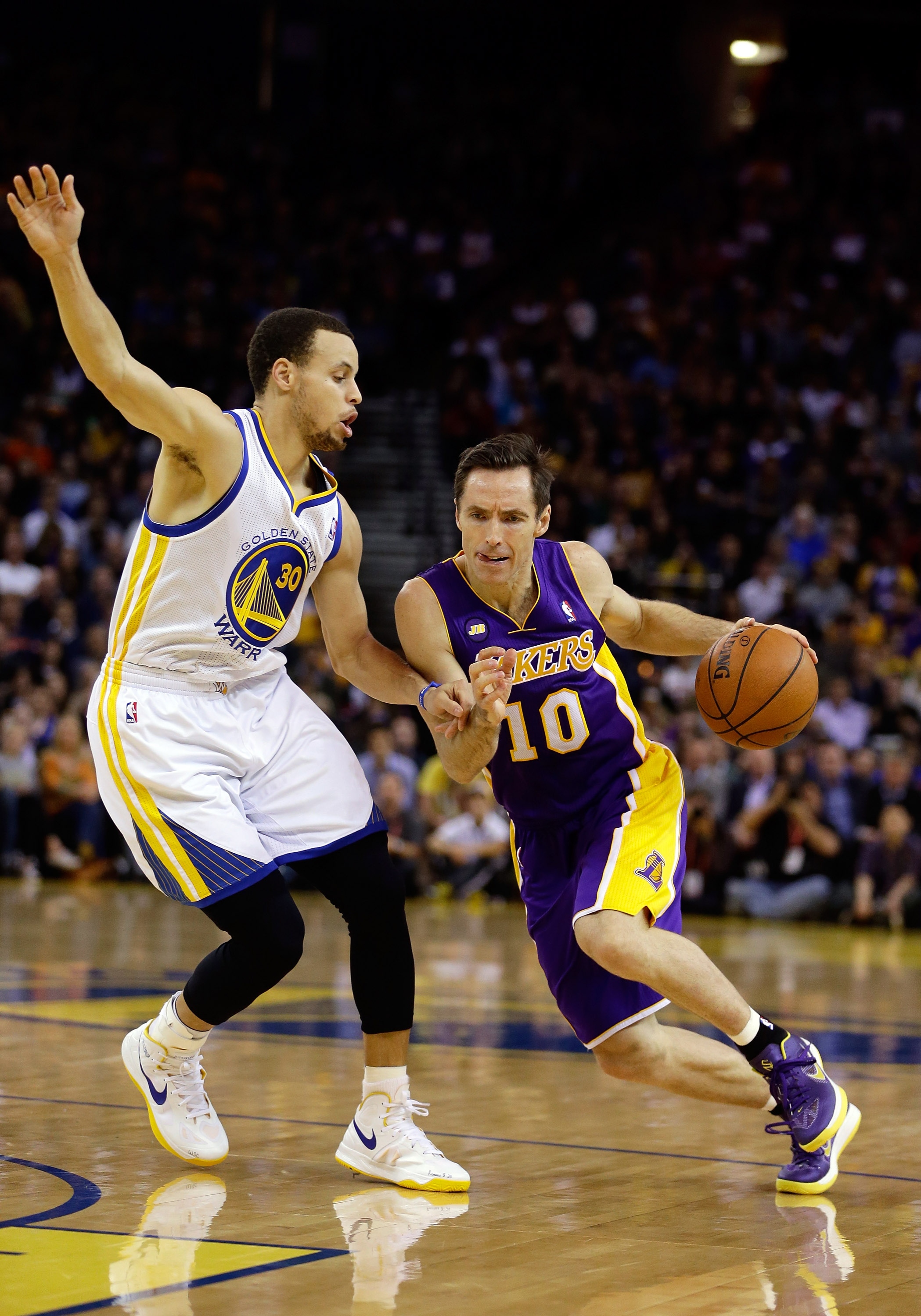 OAKLAND, CA - MARCH 25: Steve Nash #10 of the Los Angeles Lakers drives on Stephen Curry #30 of the Golden State Warriors at Oracle Arena on March 25, 2013 in Oakland, California.  NOTE TO USER: User expressly acknowledges and agrees that, by downloading and or using this photograph, User is consenting to the terms and conditions of the Getty Images License Agreement.  (Photo by Ezra Shaw/Getty Images)