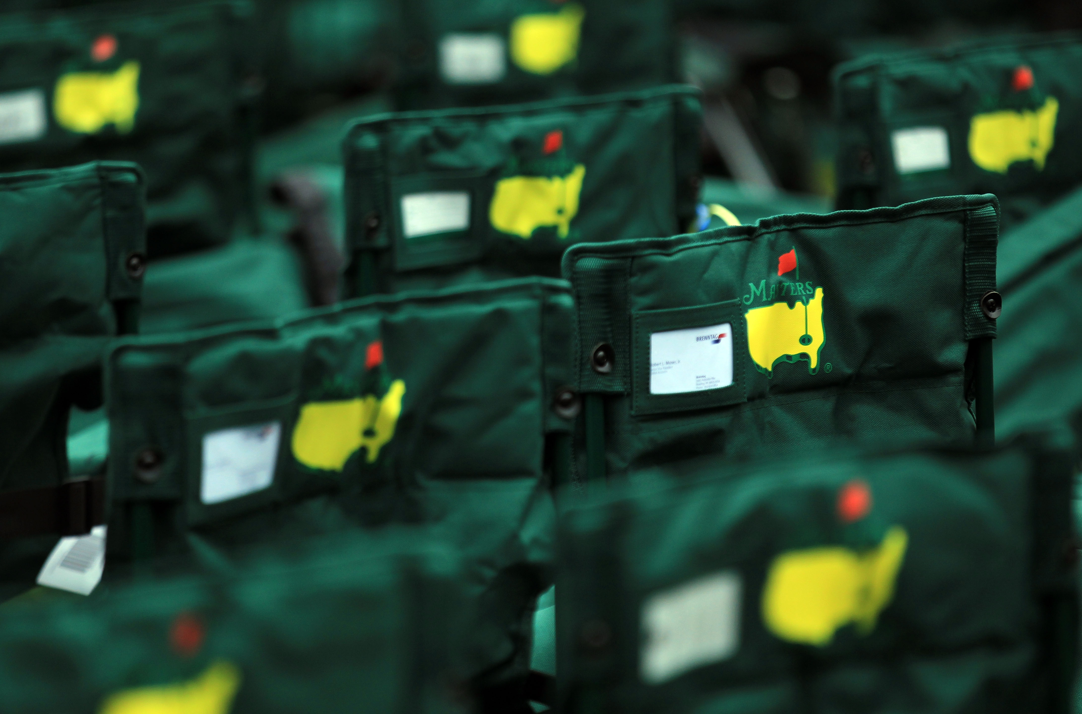 People place their names in cards on the backs of their chairs. (Getty Images)