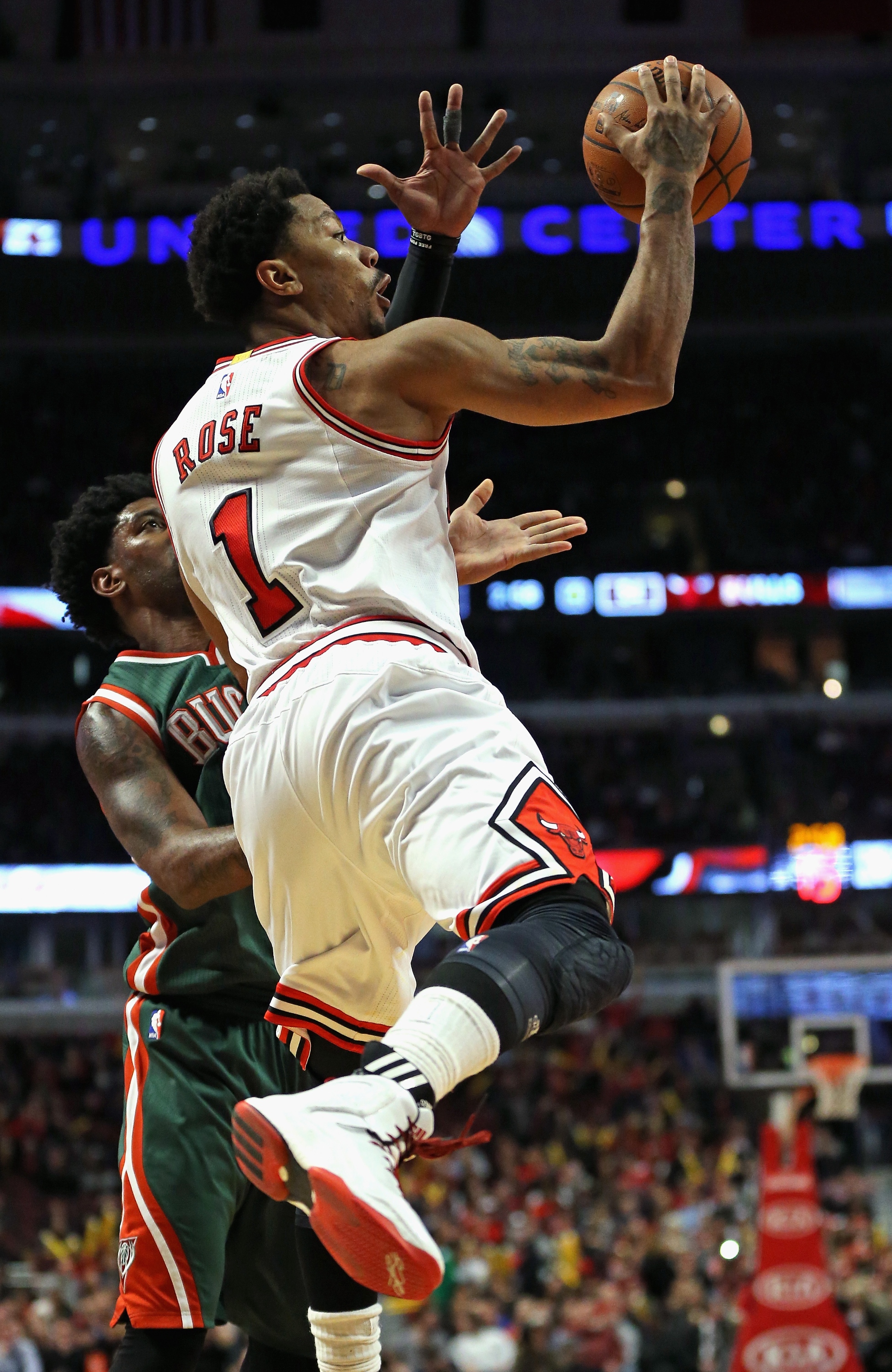 CHICAGO, IL - FEBRUARY 23: Derrick Rose #1 of the Chicago Bulls leaps to pass over O.J. Mayo #00 of the Milwaukee Bucks at the United Center on February 23, 2015 in Chicago, Illinois. The Bulls defeated the Bucks 87-71. NOTE TO USER: User expressly acknowledges and agrees that, by downloading and or using this photograph, User is consenting to the terms and conditions of the Getty Images License Agreement. (Photo by Jonathan Daniel/Getty Images)