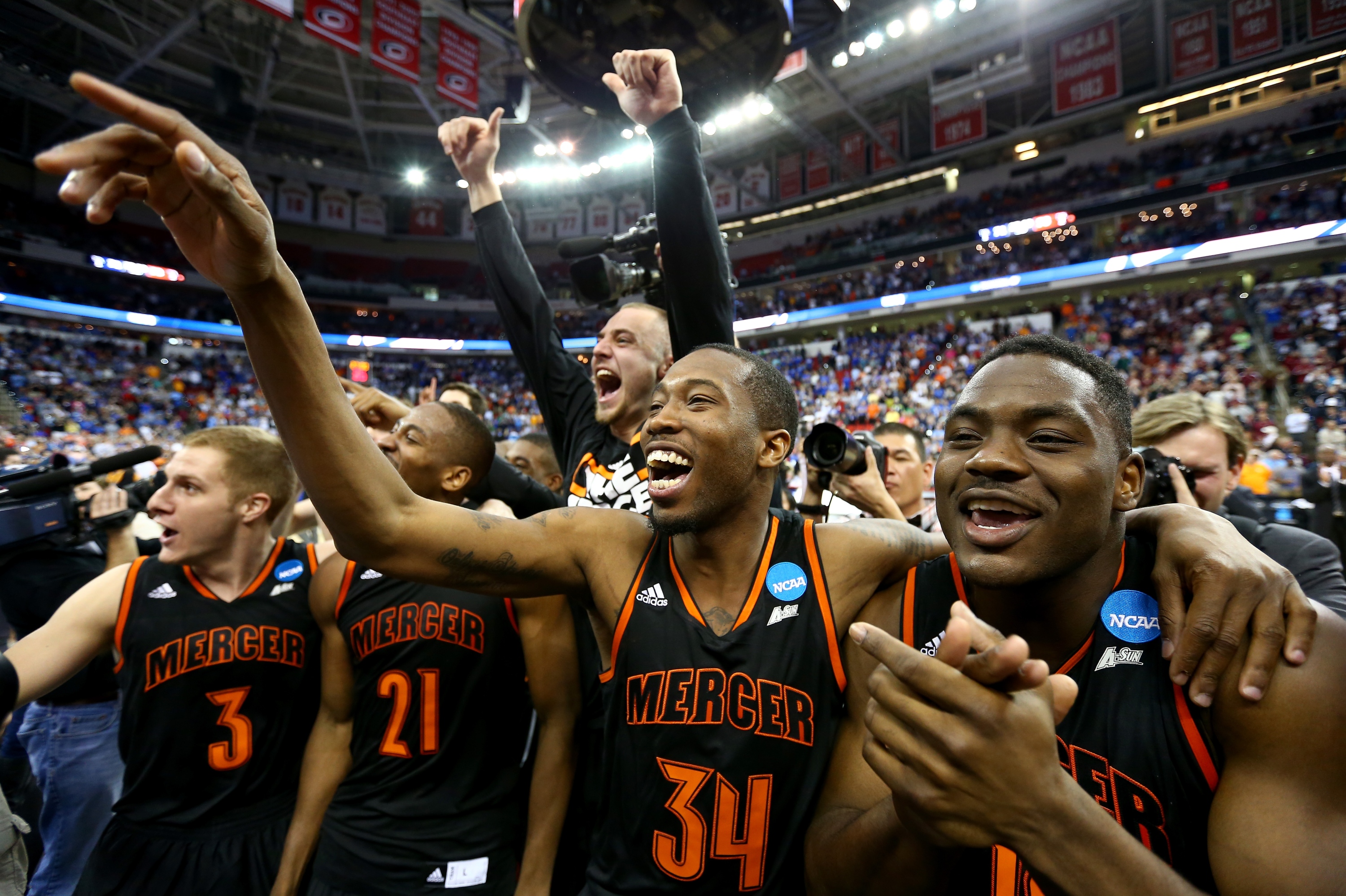 RALEIGH, NC - MARCH 21: Jibri Bryan #34 of the Mercer Bears celebrates with teammates after defeating the Duke Blue Devils 78-71 during the Second Round of the 2014 NCAA Basketball Tournament at PNC Arena on March 21, 2014 in Raleigh, North Carolina. (Photo by Streeter Lecka/Getty Images)