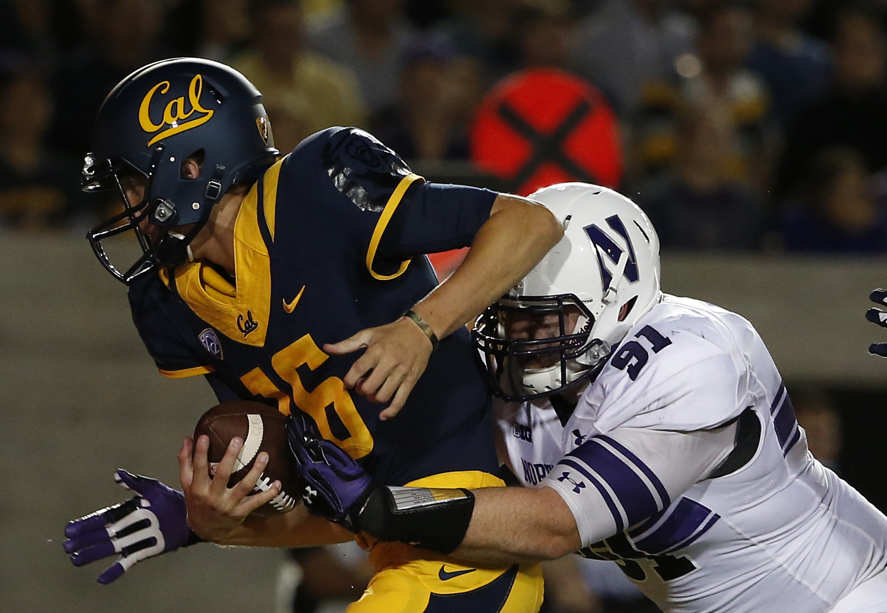BERKELEY, CA - AUGUST 31: Sean McEvilly #91 of the Northwestern Wildcats pressures quarterback Jared Goff #16 of the California Golden Bears during the first period on August 31, 2013 at California Memorial Stadium in Berkeley, California. (Photo by Stephen Lam/Getty Images)