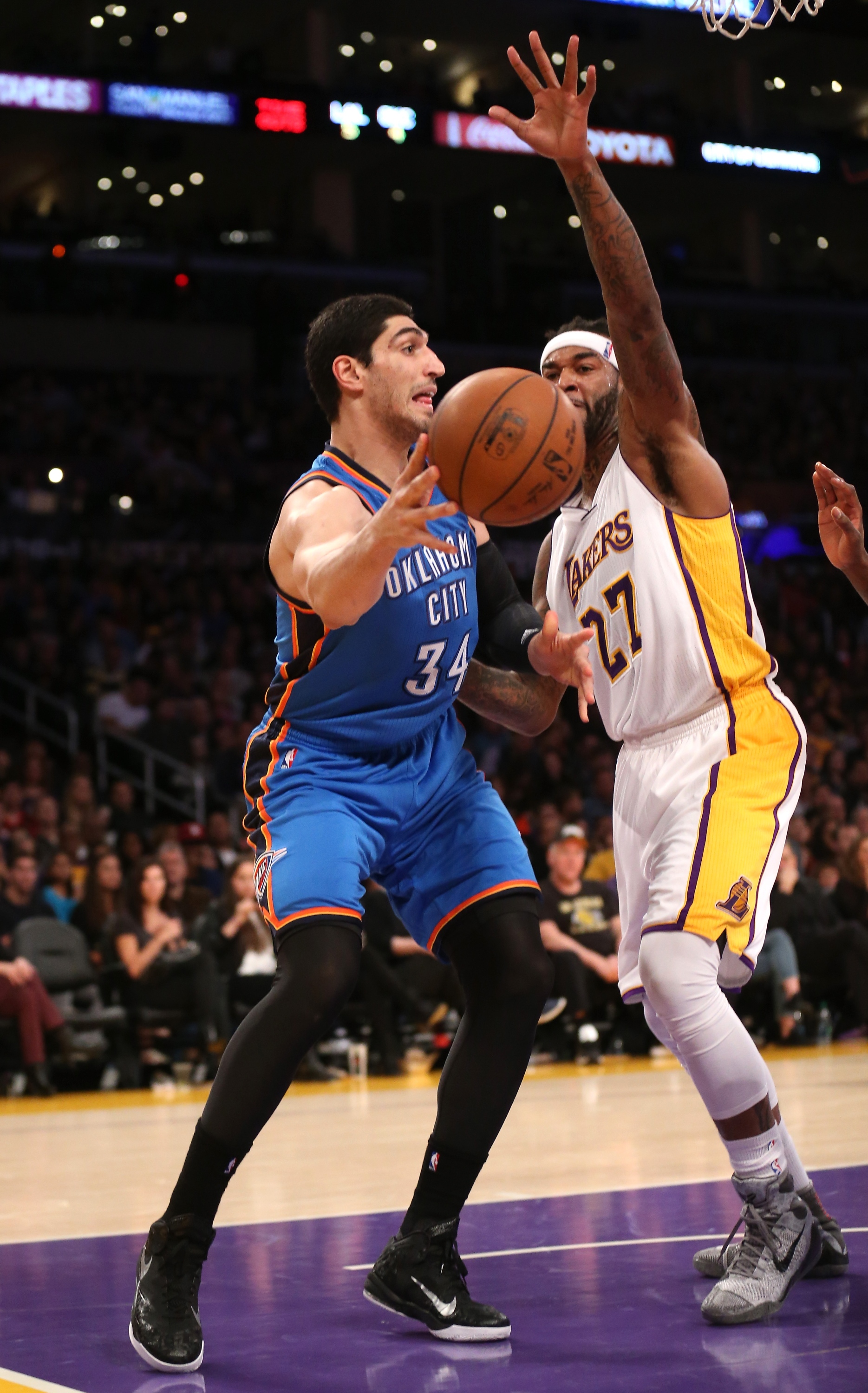 LOS ANGELES, CA - MARCH 01:  Enes Kanter #34 of the Oklahoma City Thunder throws a pass around  Jordan Hill #27 f the Los Angeles Lakers at Staples Center on March 1, 2015 in Los Angeles, California.   NOTE TO USER: User expressly acknowledges and agrees that, by downloading and or using this photograph, User is consenting to the terms and conditions of the Getty Images License Agreement.  (Photo by Stephen Dunn/Getty Images)
