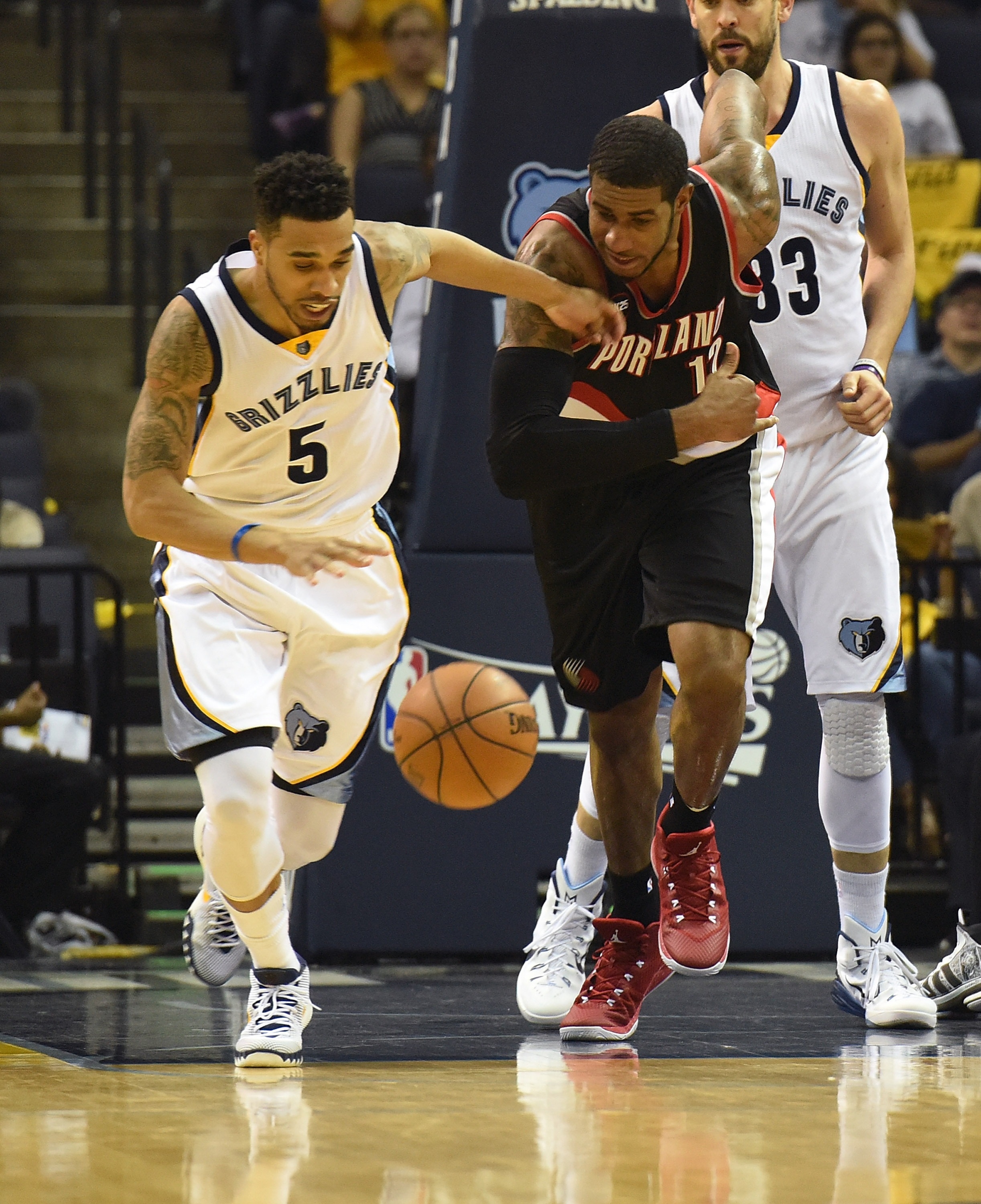 MEMPHIS, TN - APRIL 22: LaMarcus Aldridge #12 of the Portland Trailblazers and Courtney Lee #5 of the Memphis Grizzlies chase a loose ball during the first half of Game Two of the first round of the NBA Playoffs at FedExForum on April 22, 2015 in Memphis, Tennessee. NOTE TO USER: User expressly acknowledges and agrees that, by downloading and/or using this photograph, user is consenting to the terms and conditions of the Getty Images License Agreement. (Photo by Frederick Breedon/Getty Images)