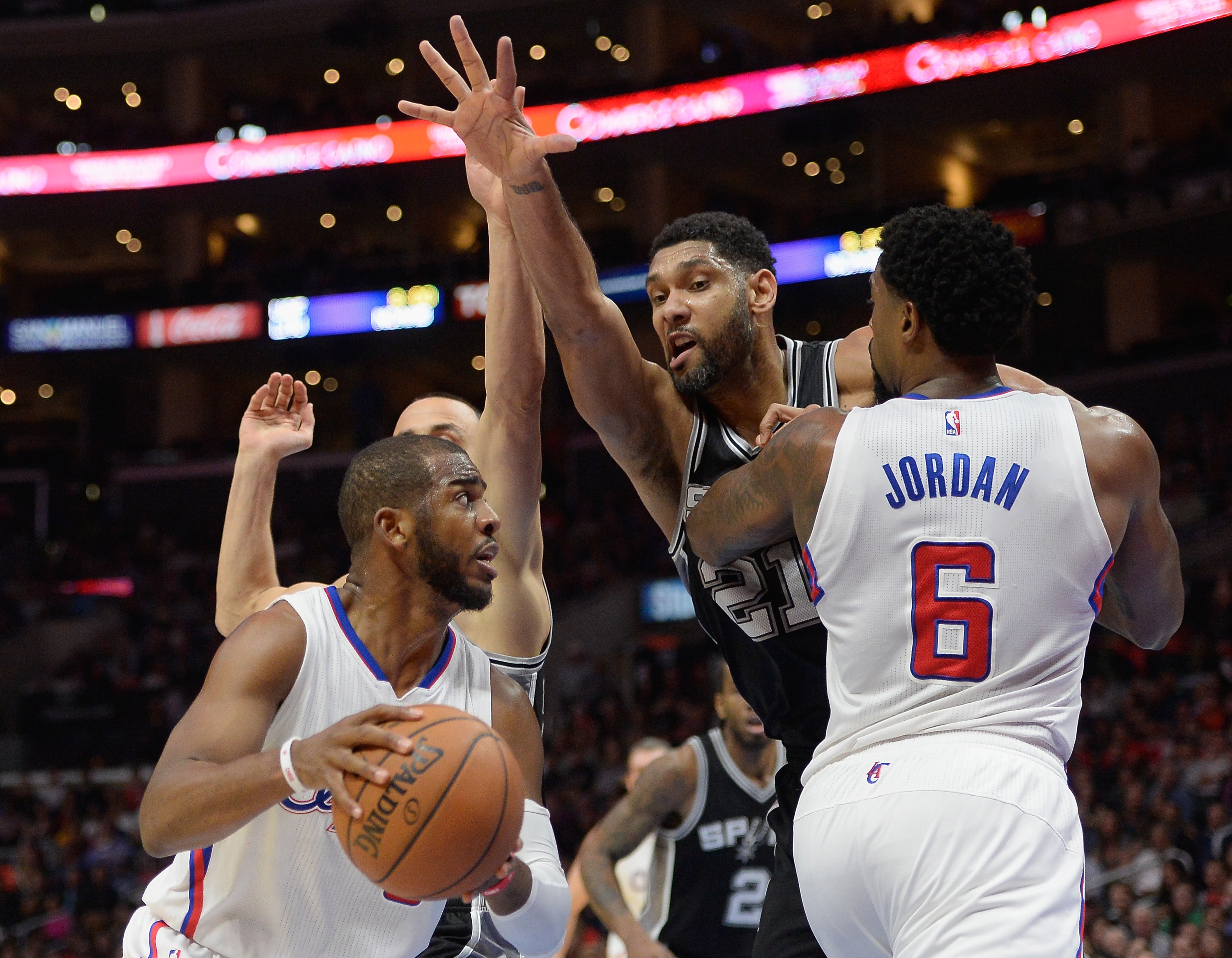 LOS ANGELES, CA - FEBRUARY 19: Tim Duncan #21 of the San Antonio Spurs chases Chris Paul #3 of the Los Angeles Clippers around the screen of DeAndre Jordan #6 at Staples Center on February 19, 2015 in Los Angeles, California. NOTE TO USER: User expressly acknowledges and agrees that, by downloading and or using this Photograph, user is consenting to the terms and condition of the Getty Images License Agreement. (Photo by Harry How/Getty Images)