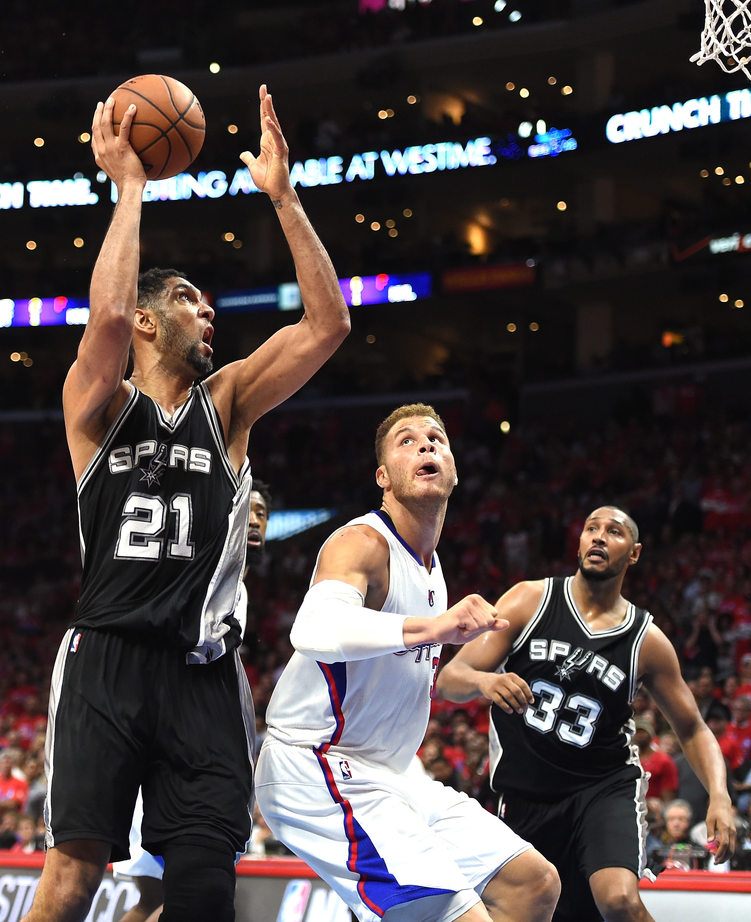 LOS ANGELES, CA - APRIL 22: Tim Duncan #21 of the San Antonio Spurs shoots over Blake Griffin #32 of the Los Angeles Clippers as Boris Diaw #33 look on during Game Two of the Western Conference quarterfinals of the 2015 NBA Playoffs at Staples Center on April 22, 2015 in Los Angeles, California. NOTE TO USER: User expressly acknowledges and agrees that, by downloading and or using this Photograph, user is consenting to the terms and condition of the Getty Images License Agreement. The Spurs won 111-107. (Photo by Harry How/Getty Images)