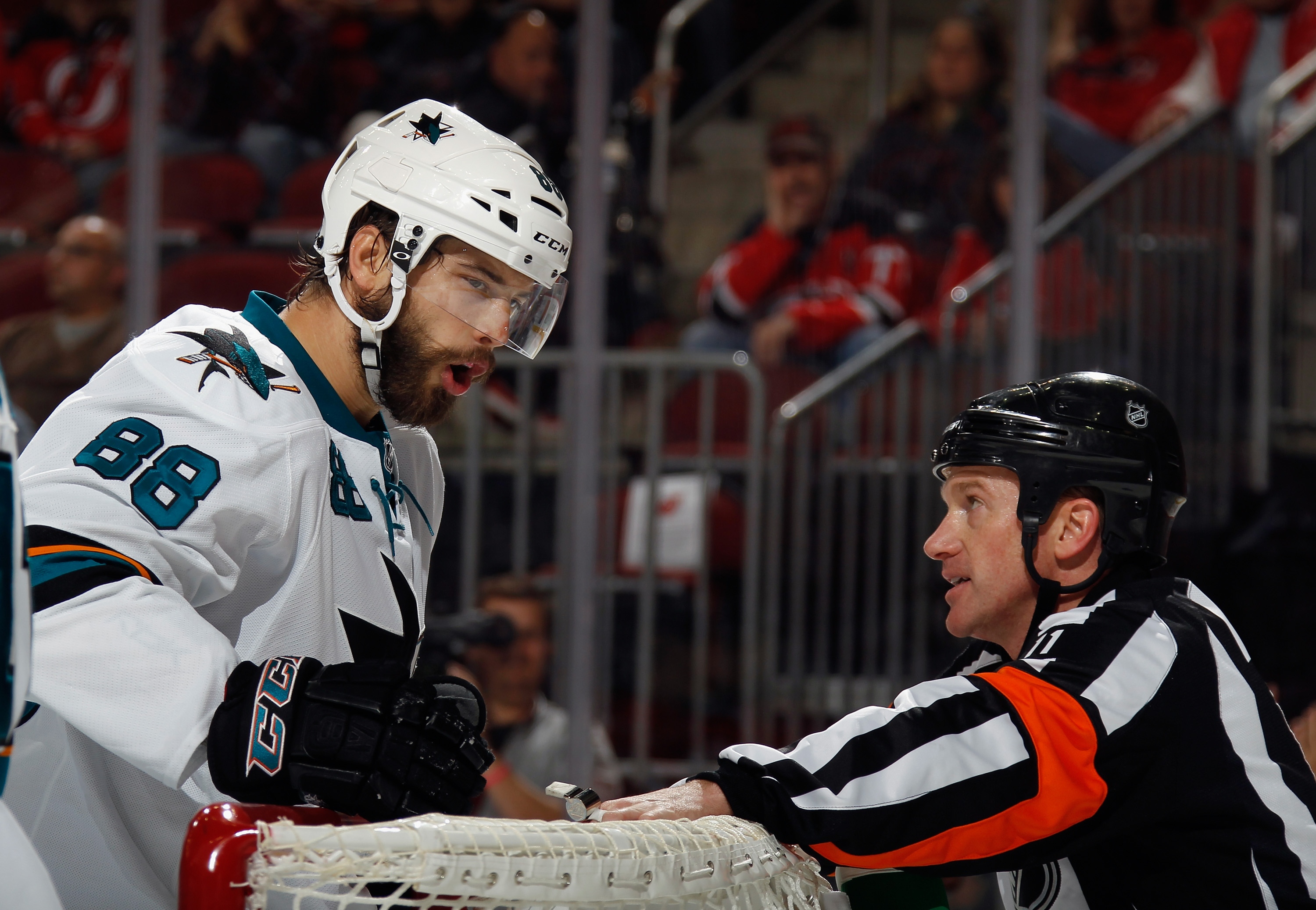 NEWARK, NJ - OCTOBER 18: Brent Burns #88 of the San Jose Sharks argues a second period call with referee Kelly Sutherland #11 during the game against the New Jersey Devils at the Prudential Center on October 18, 2014 in Newark, New Jersey.  (Photo by Bruce Bennett/Getty Images)