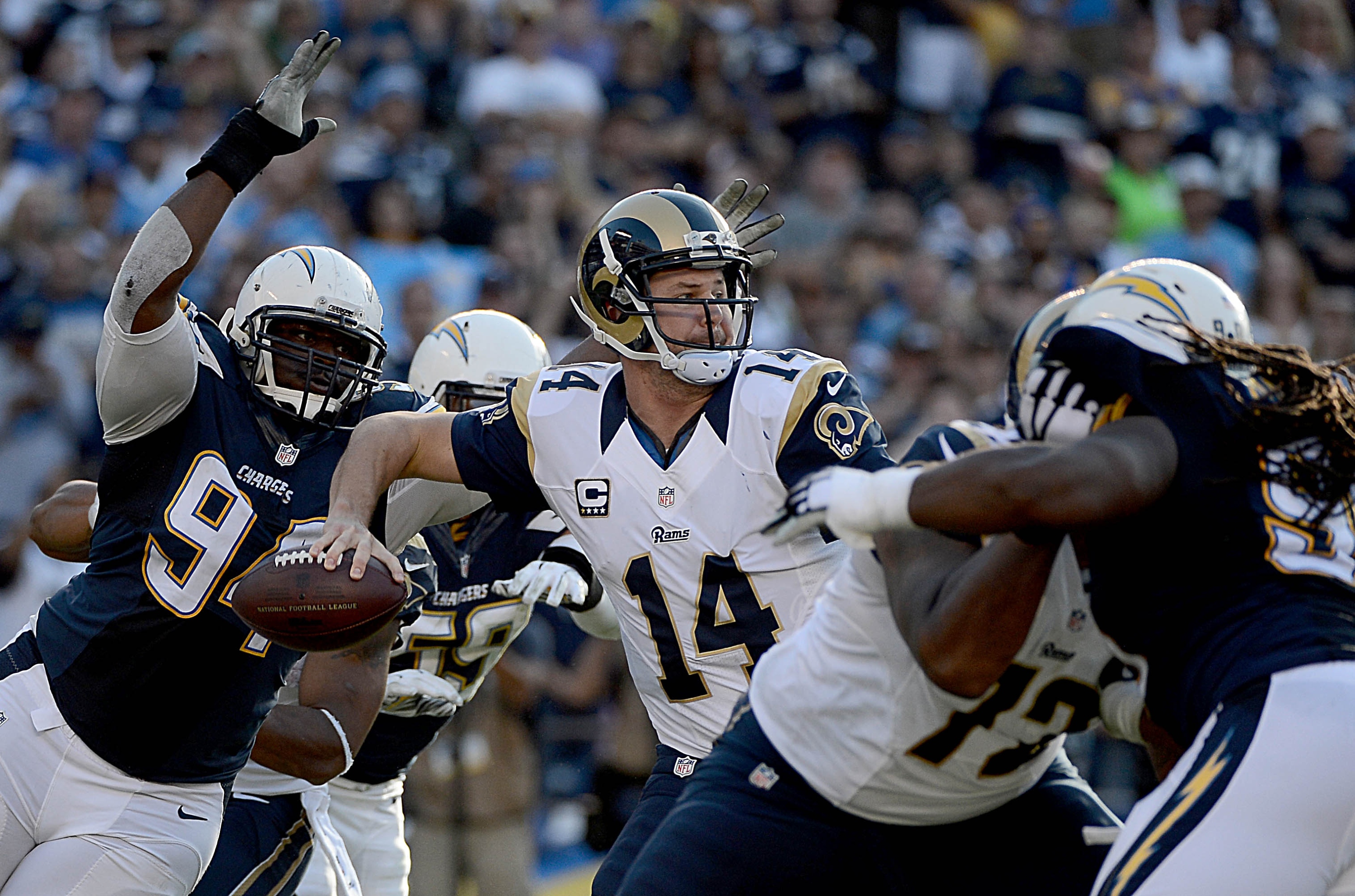 SAN DIEGO, CA- NOVEMBER 23:  Quarterback Shaun Hill #14 of the St. Louis Rams has the ball knocked out of his hand by Corey Liuget #94 of the San Diego Chargers which resulted in a fumble and touchdown during their NFL Game on November 23, 2014 in San Diego, California. (Photo by Donald Miralle/Getty Images)