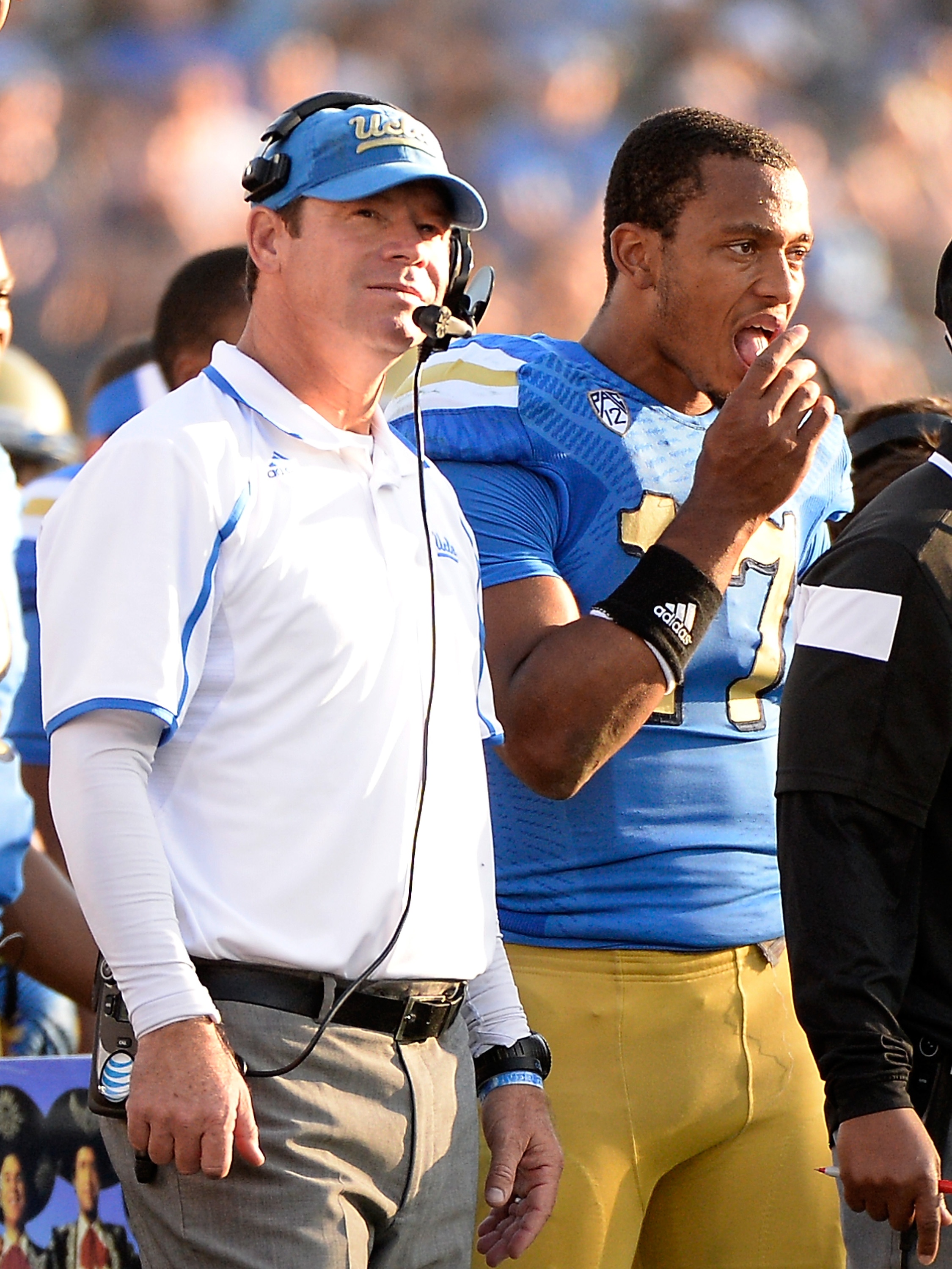 PASADENA, CA - NOVEMBER 28: Brett Hundley #17 of the UCLA Bruins and head coach Jim Mora watch a 31-10 loss to the Stanford Cardinal at Rose Bowl on November 28, 2014 in Pasadena, California. (Photo by Harry How/Getty Images)