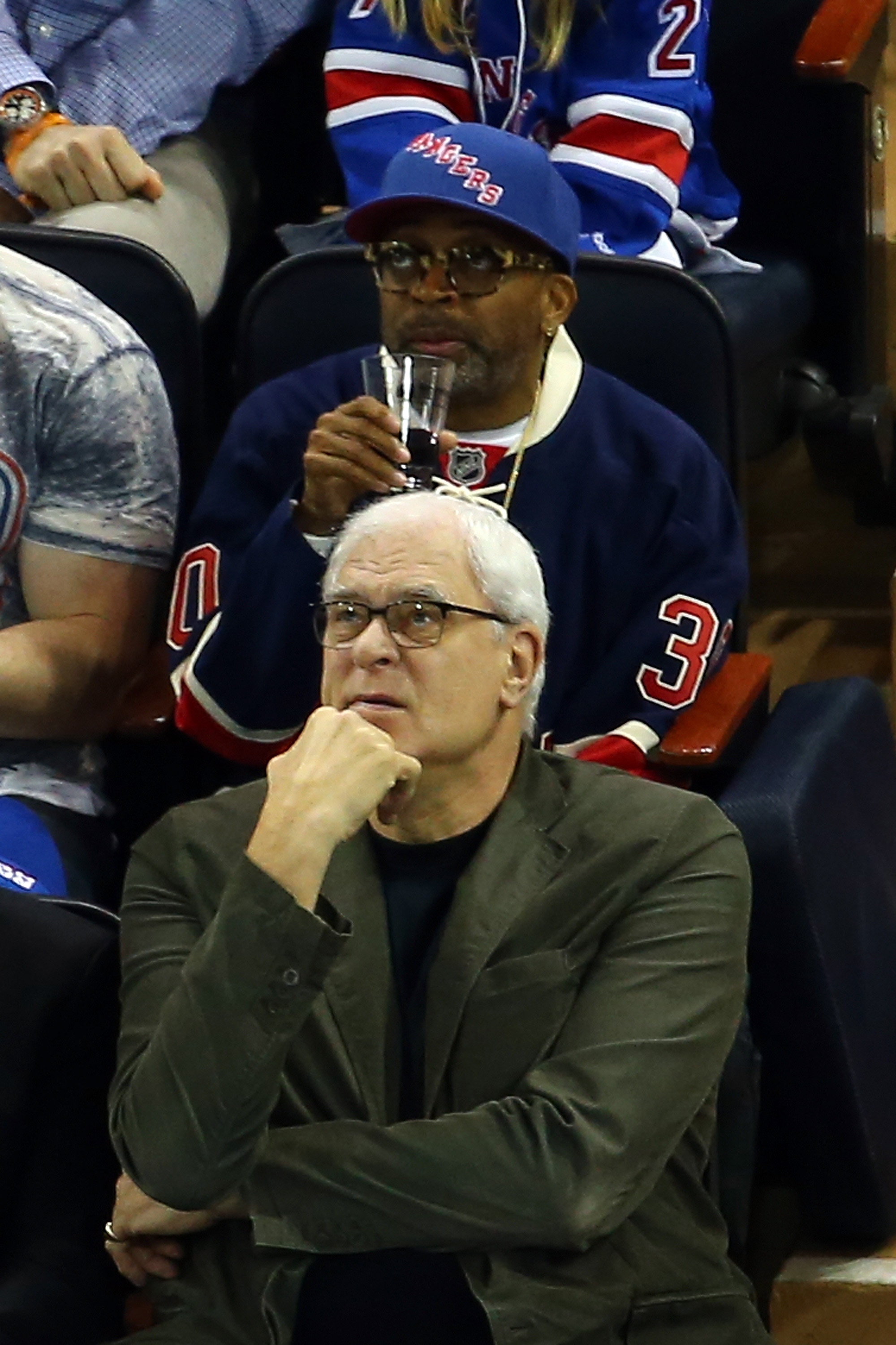 Phil Jackson and Spike Lee scout hockey players. (Photo by Elsa/Getty Images)