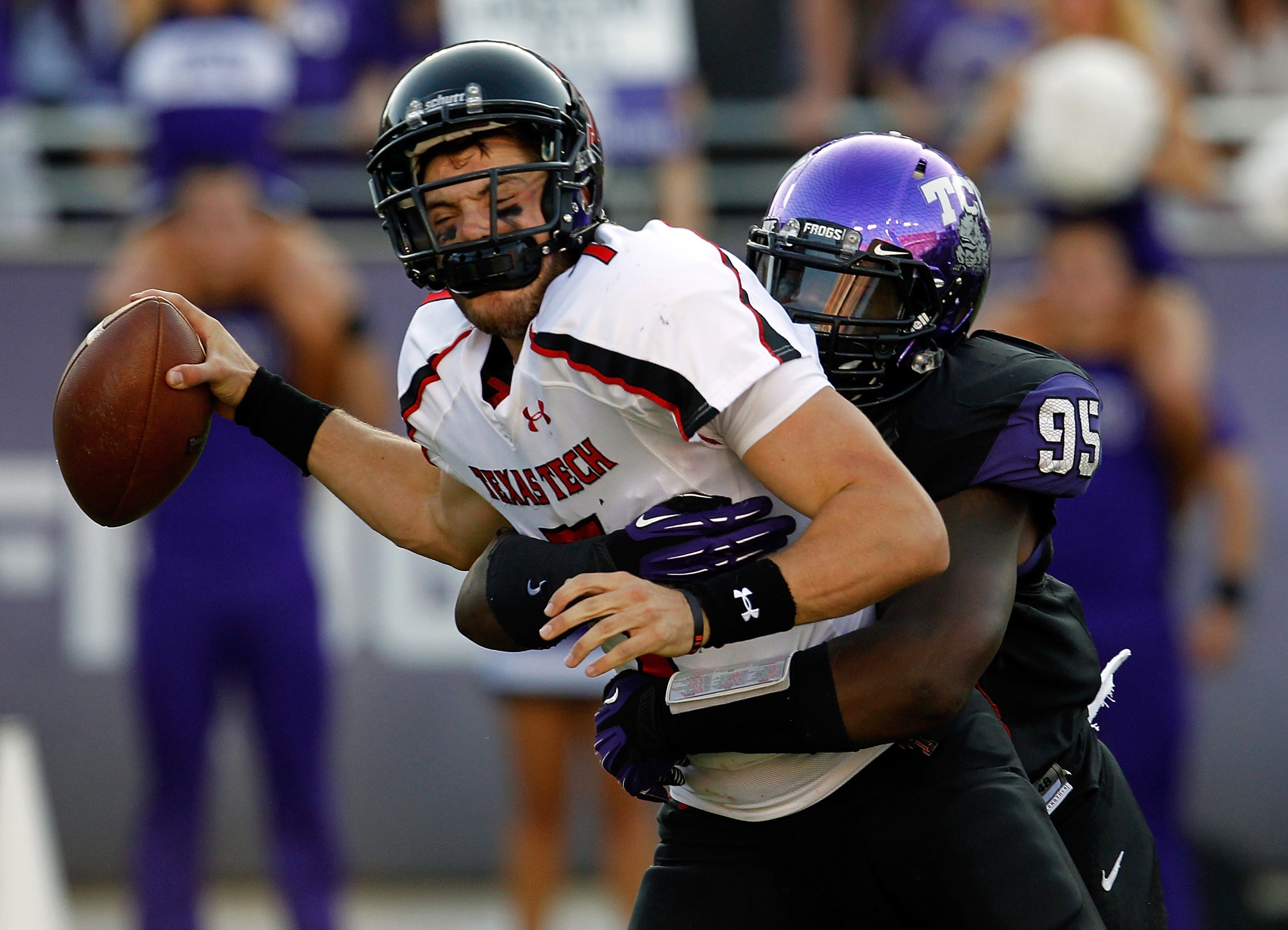 Seth Doege #7 of the Texas Tech Red Raiders is sacked for a loss by Devonte Fields #95 of the TCU Horned Frogs. (Photo by Tom Pennington/Getty Images)