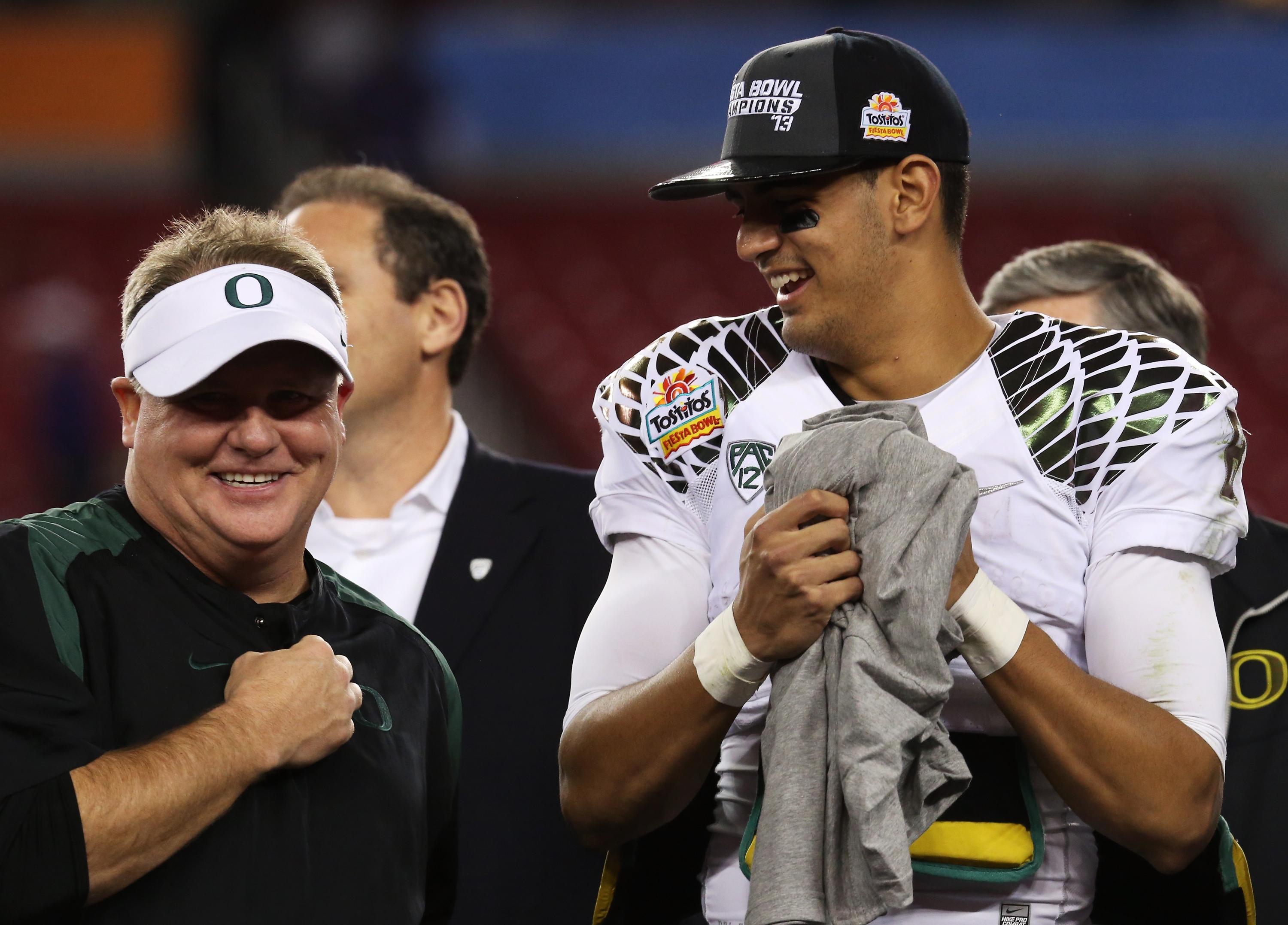 GLENDALE, AZ - JANUARY 03:  Head coach Chip Kelly celebrates with Marcus Mariota #8 of the Oregon Ducks after their 35 to 17 win over the Kansas State Wildcats in the Tostitos Fiesta Bowl at University of Phoenix Stadium on January 3, 2013 in Glendale, Arizona.  (Photo by Stephen Dunn/Getty Images)