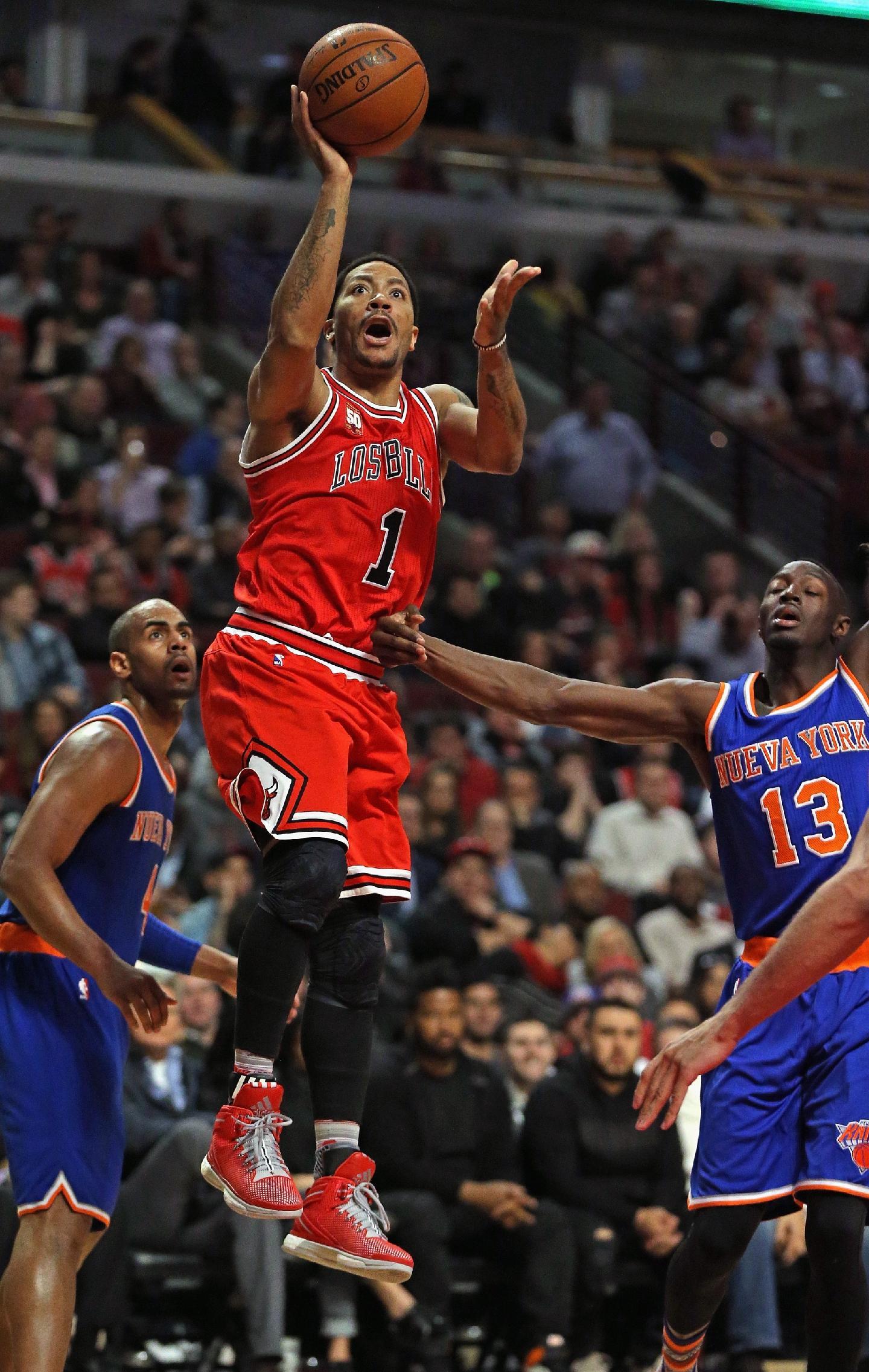 Derrick Rose shoots over the man he was traded for. (Jonathan Daniel/Getty Images)