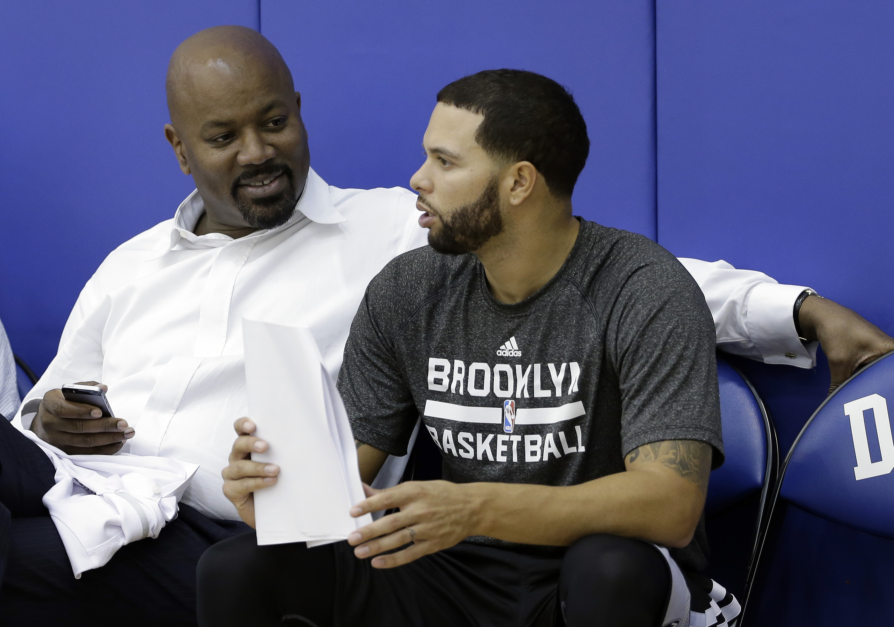 Could GM Billy King (left) have his eye on a point guard to replace Deron Williams? (AP/Gerry Broome)