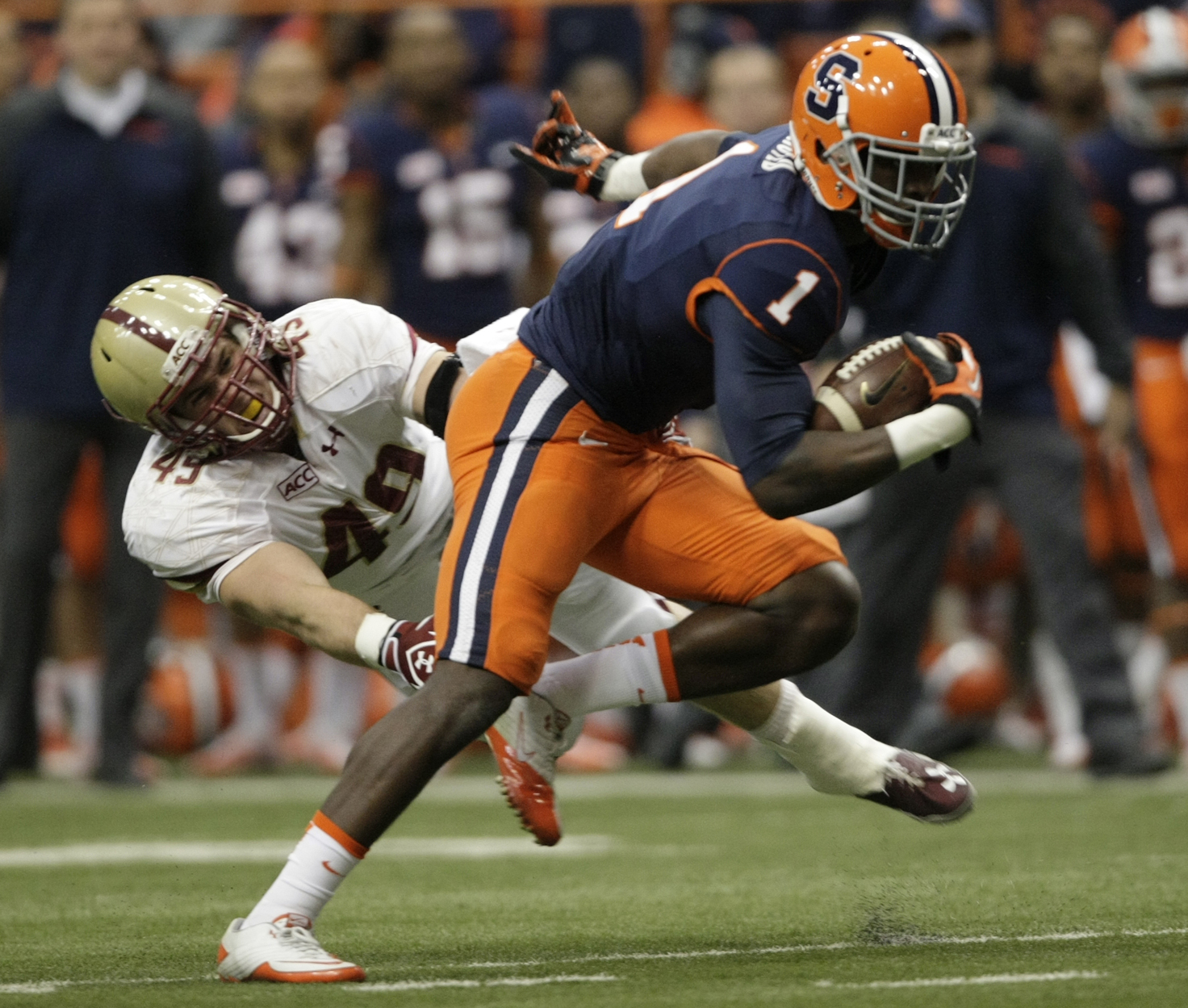 Syracuse's Ashton Broyld, right, runs past Boston College's Steele Divitto, left, in the first quarter of an NCAA college football game in Syracuse, N.Y., Saturday, Nov. 30, 2013. (AP Photo/Nick Lisi)