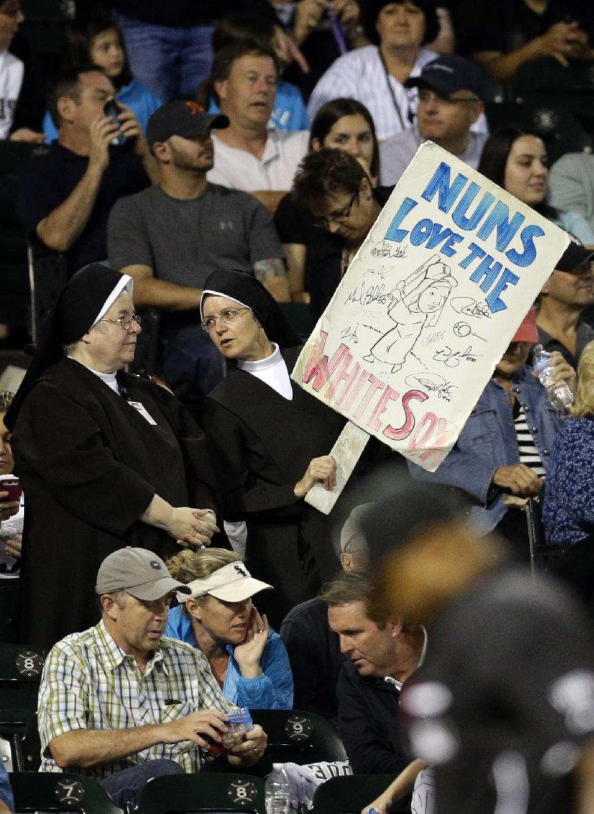 A baseball fan holds a sign during the sixth inning of a baseball game between the Cleveland Indians and the Chicago White Sox in Chicago, Thursday, Aug. 28, 2014. (AP Photo/Nam Y. Huh)