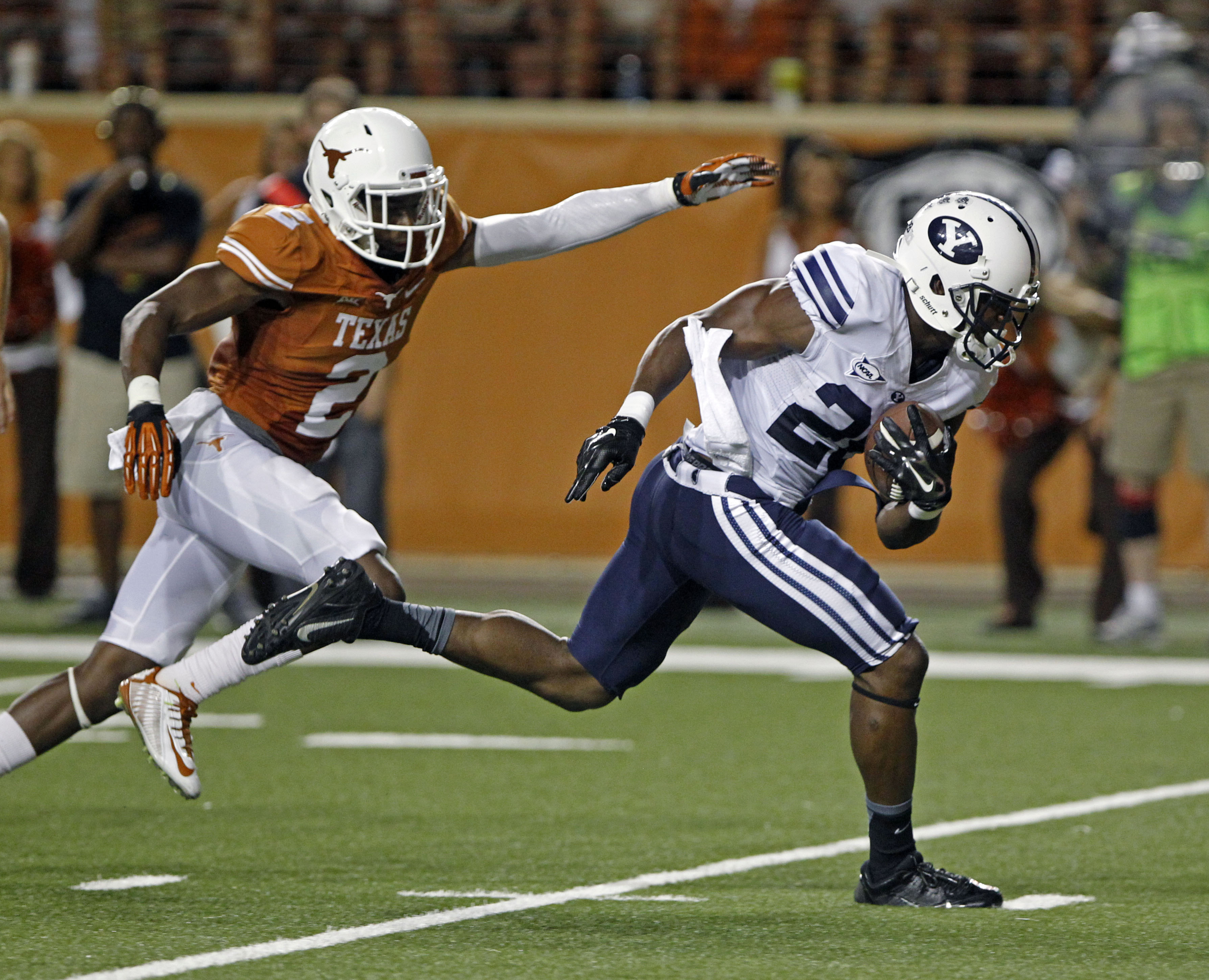 BYU running back Jamaal Williams (21) runs for a touchdown against Texas' Duke Thomas (2) during the third quarter of an NCAA college football game in Austin, Texas, Saturday, Sept. 6, 2014. (AP Photo/Michael Thomas)