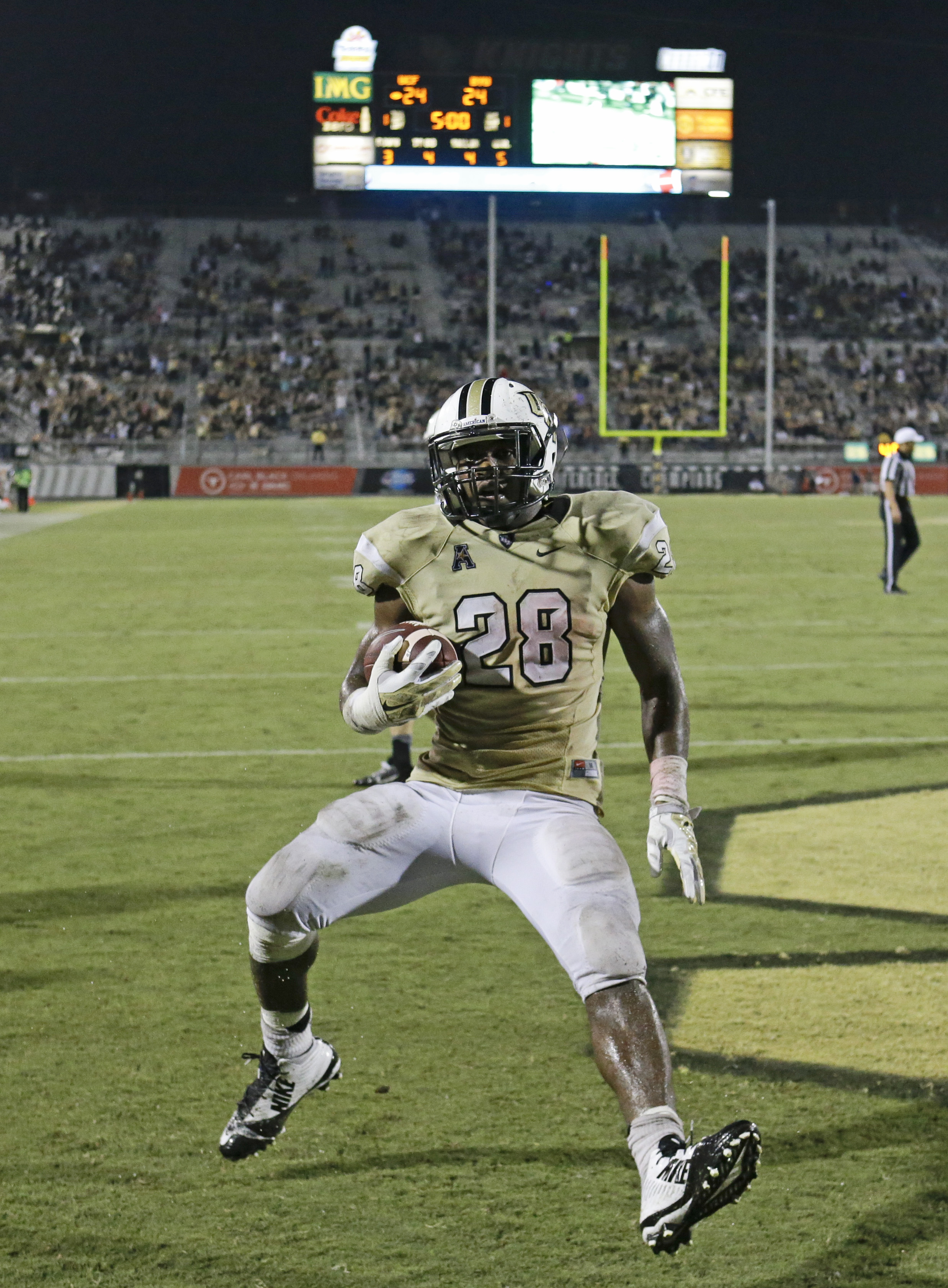 Central Florida running back William Stanback (28) runs in the end zone to score the winning touchdown against Brigham Young in overtime at an NCAA college football game in Orlando, Fla., Thursday, Oct. 9, 2014. Central Florida won 31-24 in overtime. (AP Photo/John Raoux)