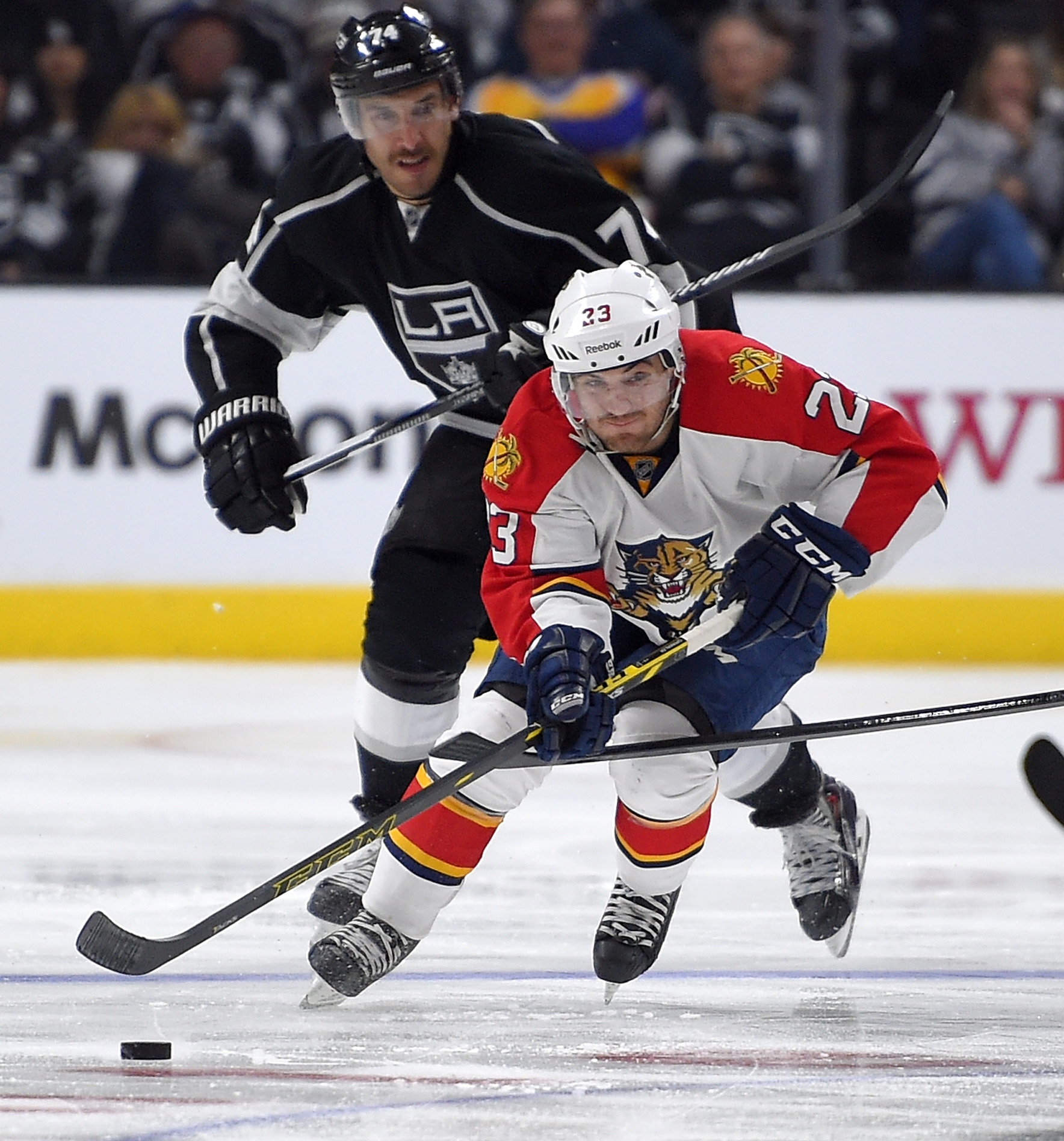 Florida Panthers Rocco Grimaldi, right, moves the puck as Los Angeles Kings left wing Dwight King gives chase during the third period of an NHL hockey game, Tuesday, Nov. 18, 2014, in Los Angeles. The Kings won 5-2. (AP Photo/Mark J. Terrill)