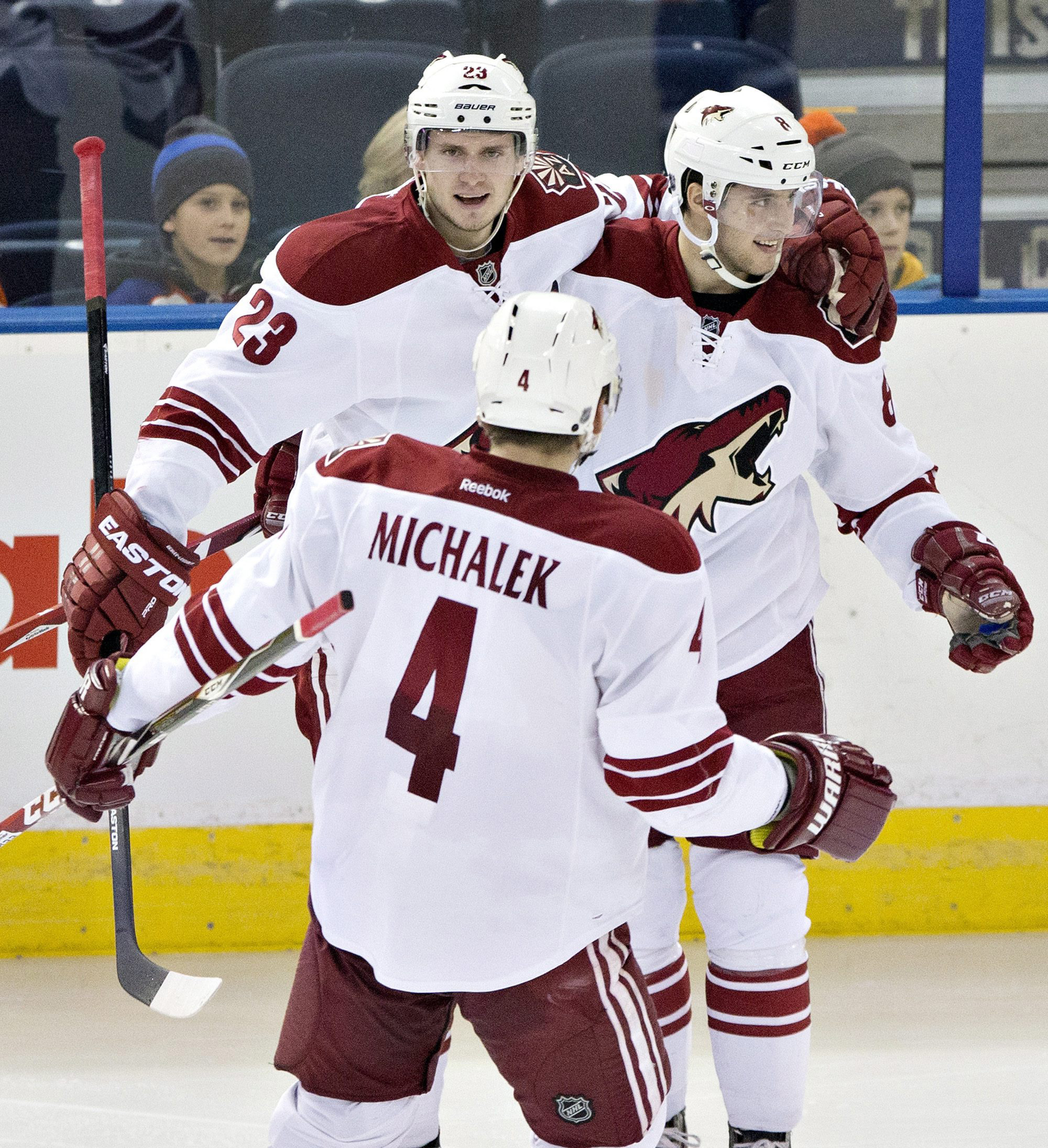 Arizona Coyotes' Oliver Ekman-Larsson (23), Tobias Rieder (8) and Zbynek Michalek (4) celebrate a goal against the Edmonton Oilers during the second period of an NHL hockey game in Edmonton, Alberta., on Monday, Dec. 1, 2014. (AP Photo/The Canadian Press, Jason Franson)