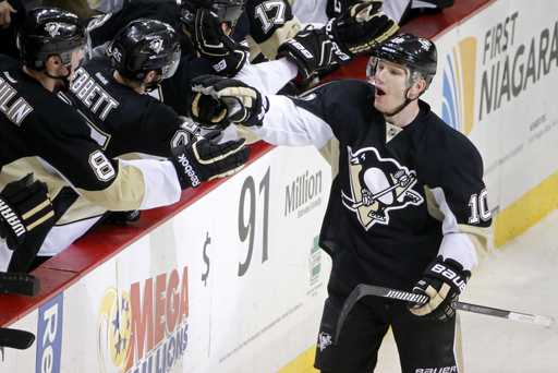 Pittsburgh Penguins' Christian Ehrhoff (10) celebrates with teammates as he returns to the bench after scoring in the third period of an NHL hockey game against the Ottawa Senators in Pittsburgh, Saturday, Dec. 6, 2014. The Penguins won 3-2. (AP Photo/Gene J. Puskar)