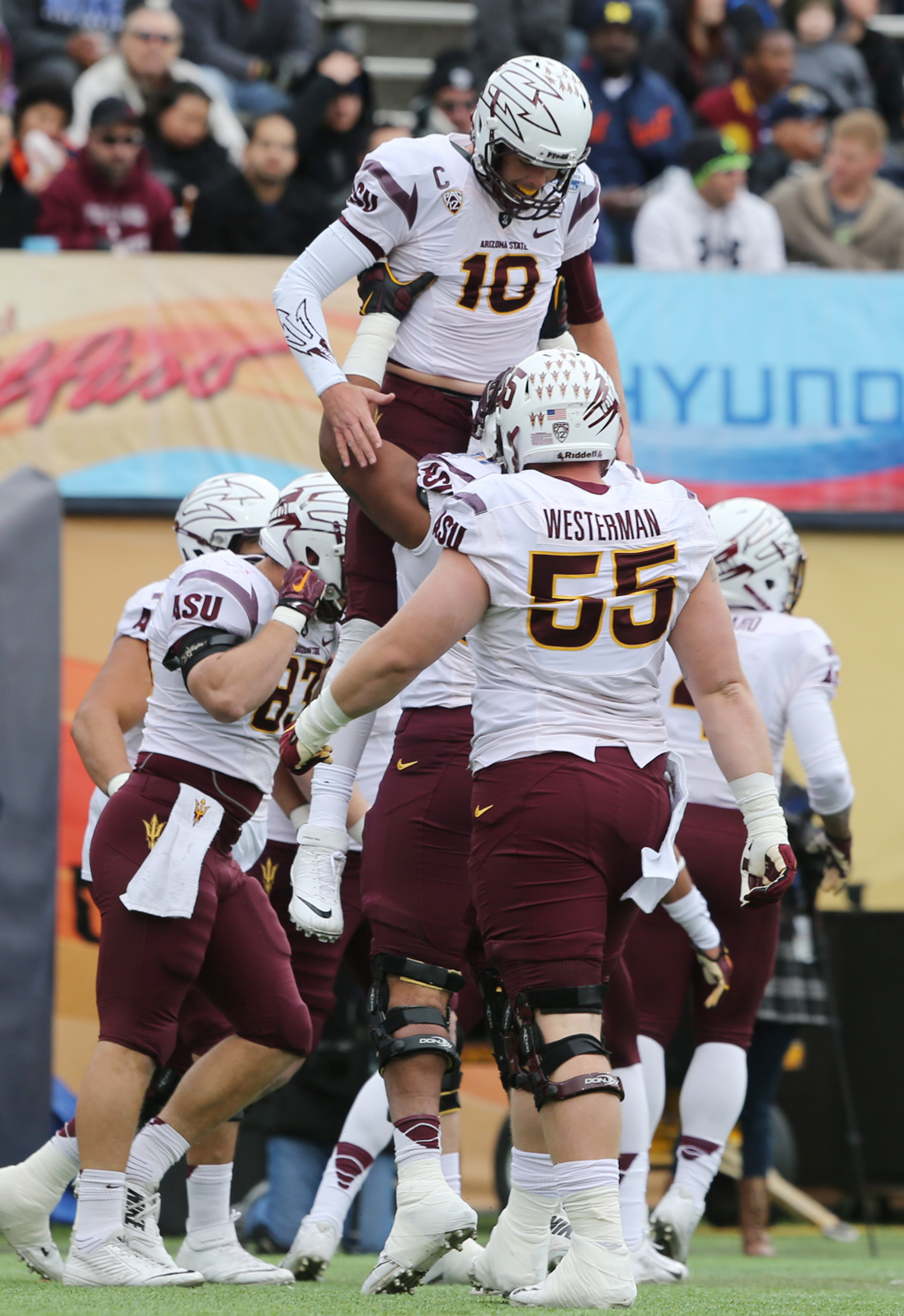 Arizona State quarterback Taylor Kelly was hoisted by teammates after scoring during the first quarter of the Sun Bowl NCAA college football game against Duke, Saturday, Dec. 27, 2014, in El Paso, Texas. (AP Photo/Victor Calzada)