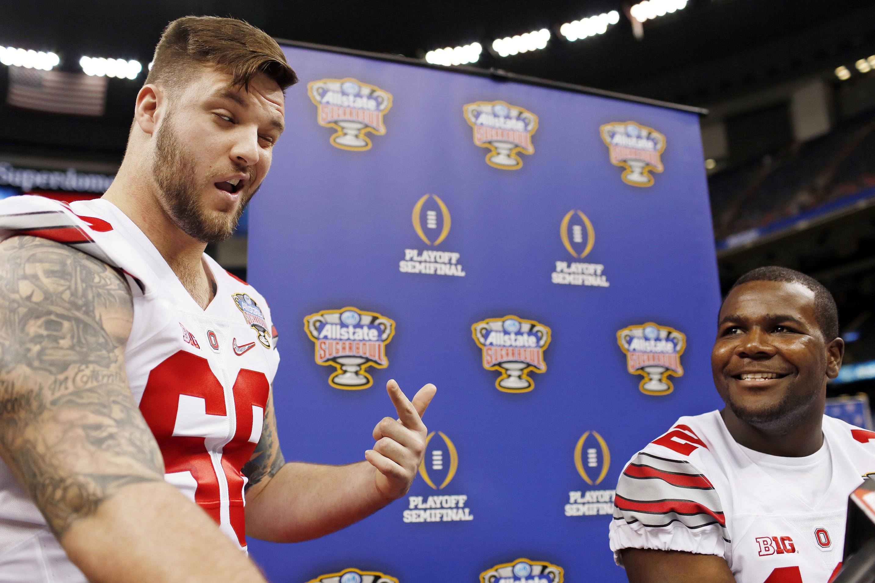 Taylor Decker (L) shares a fun moment with Cardale Jones. (AP) 