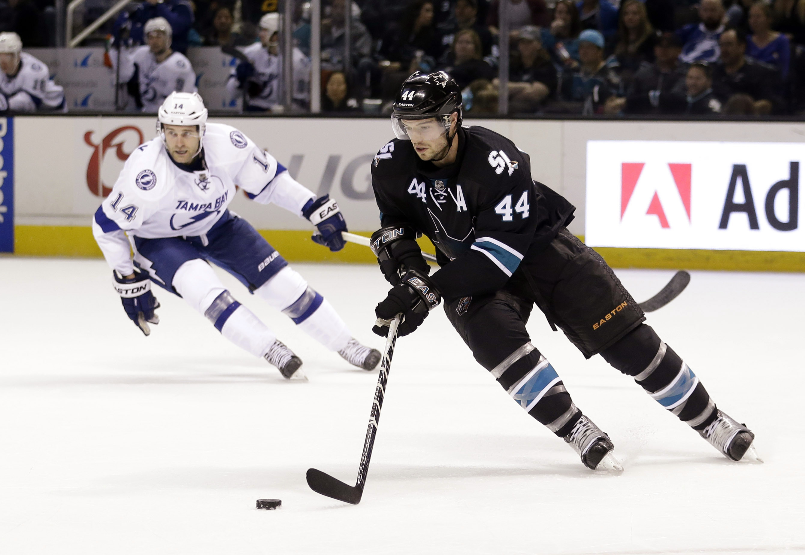 San Jose Sharks' Marc-Edouard Vlasic (44) controls the puck behind Tampa Bay Lightning's Brett Connolly (14) during the second period of an NHL hockey game Sunday, Feb. 15, 2015, in San Jose, Calif. (AP Photo/Marcio Jose Sanchez)